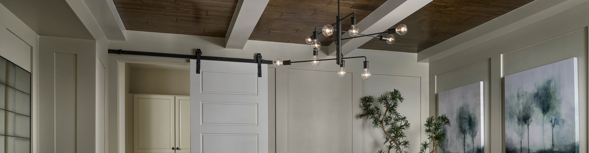 A room with white cabinets and a chandelier.