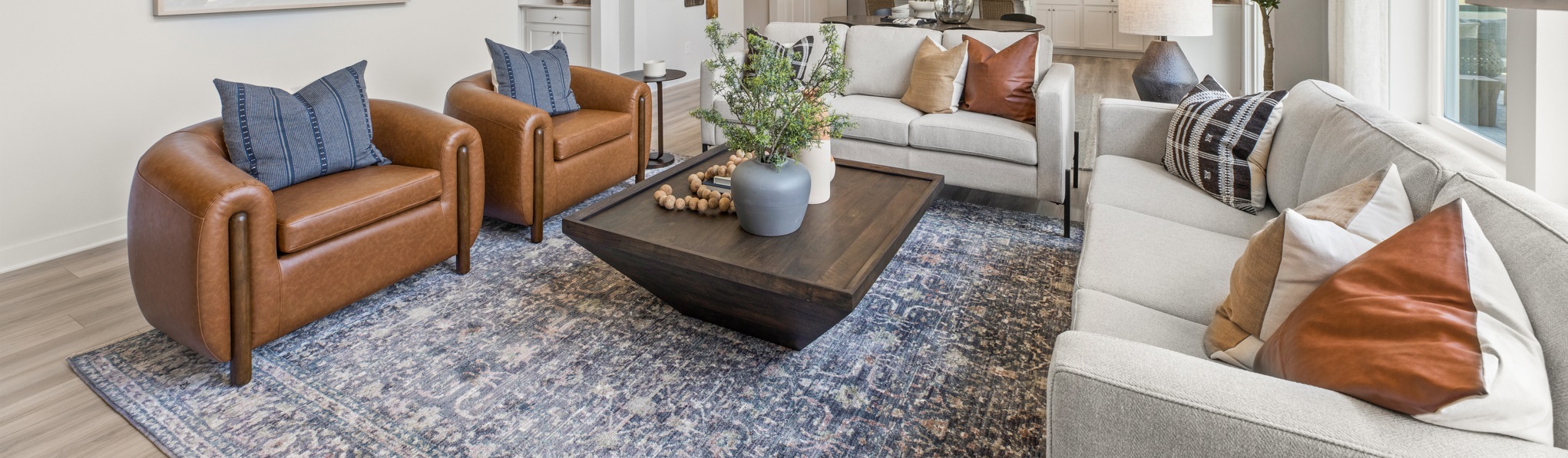 A living room with a couch and chairs.