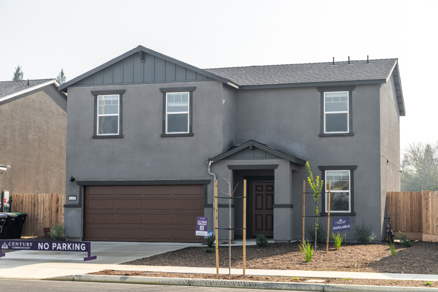A grey house with a garage.