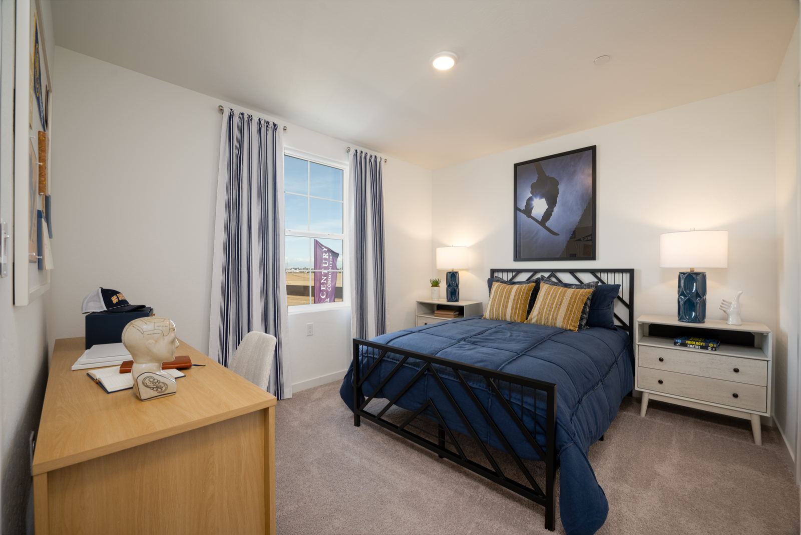 A bedroom with a bed desk and a window.