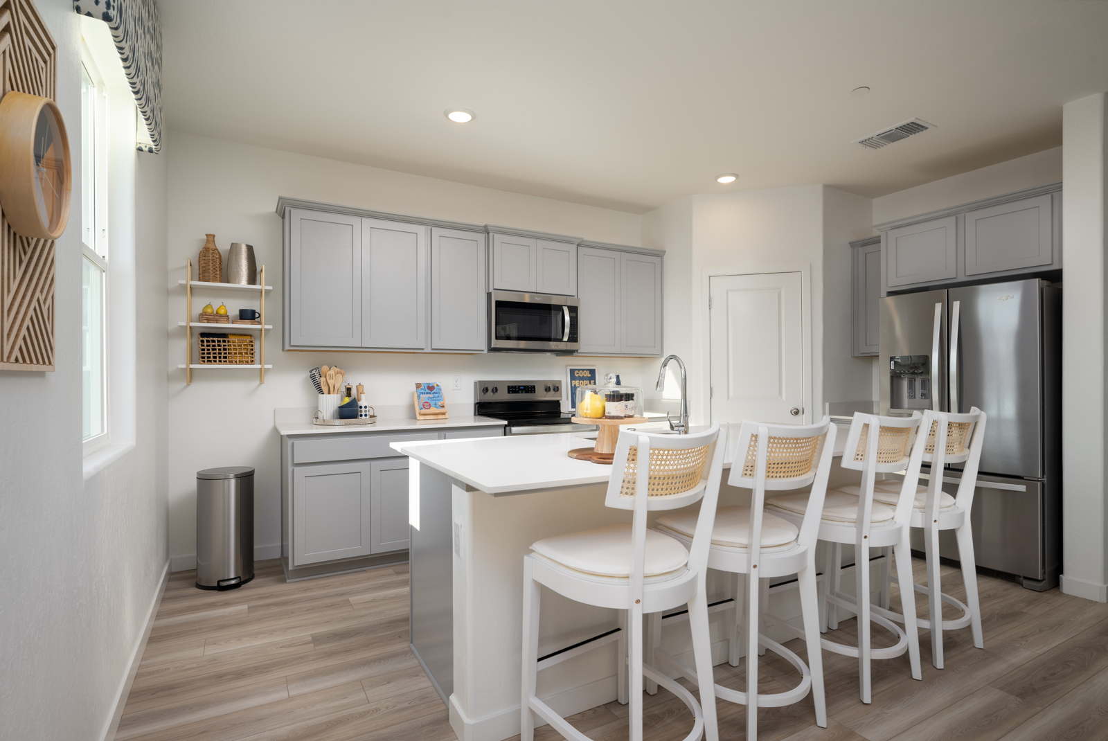 A kitchen with white cabinets.