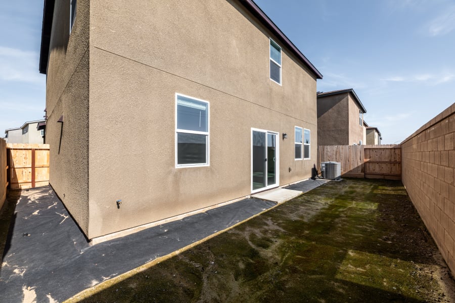 A building with a fence and grass.