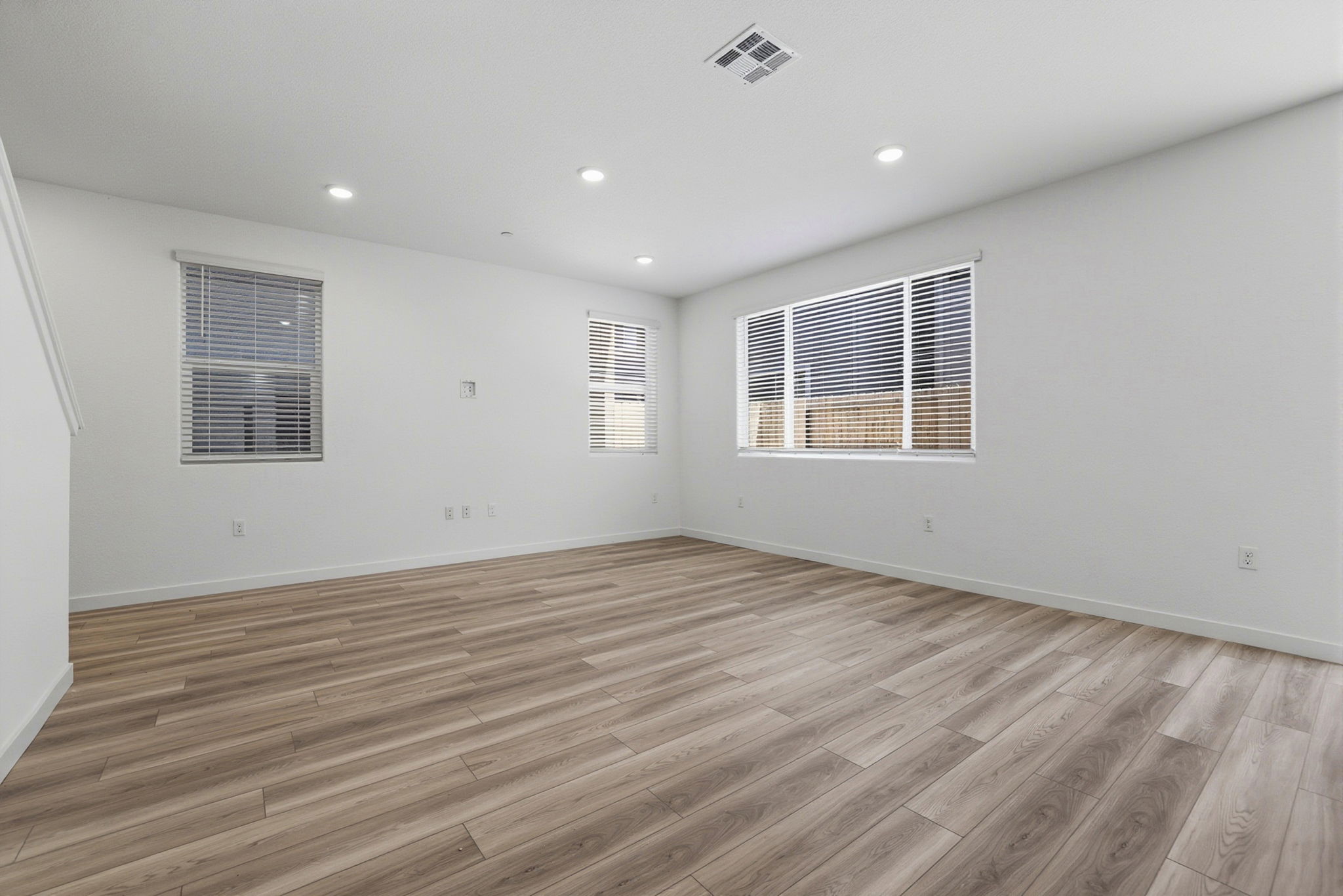 A room with a wood floor and a window.