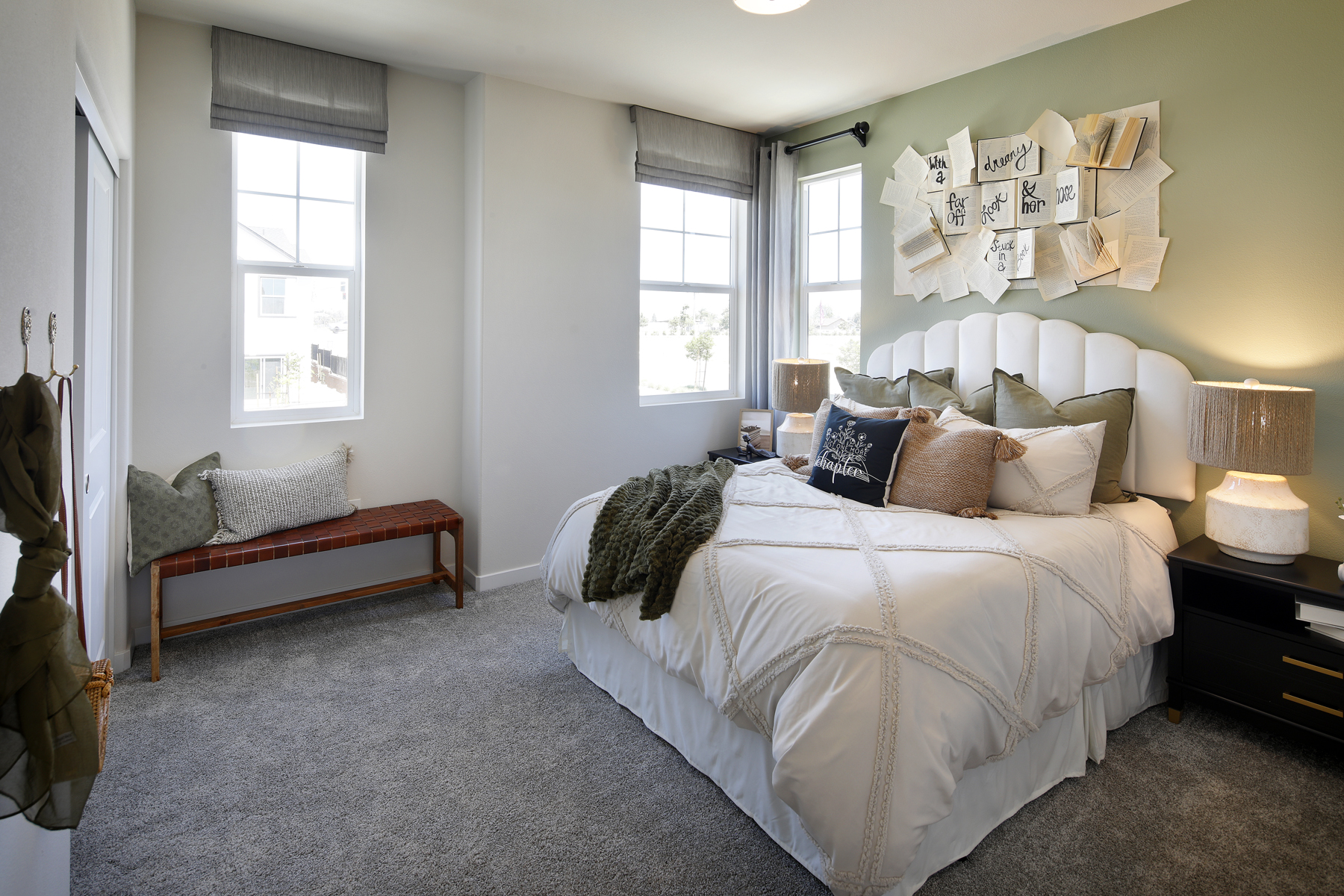 A bedroom with a bed and a bench.