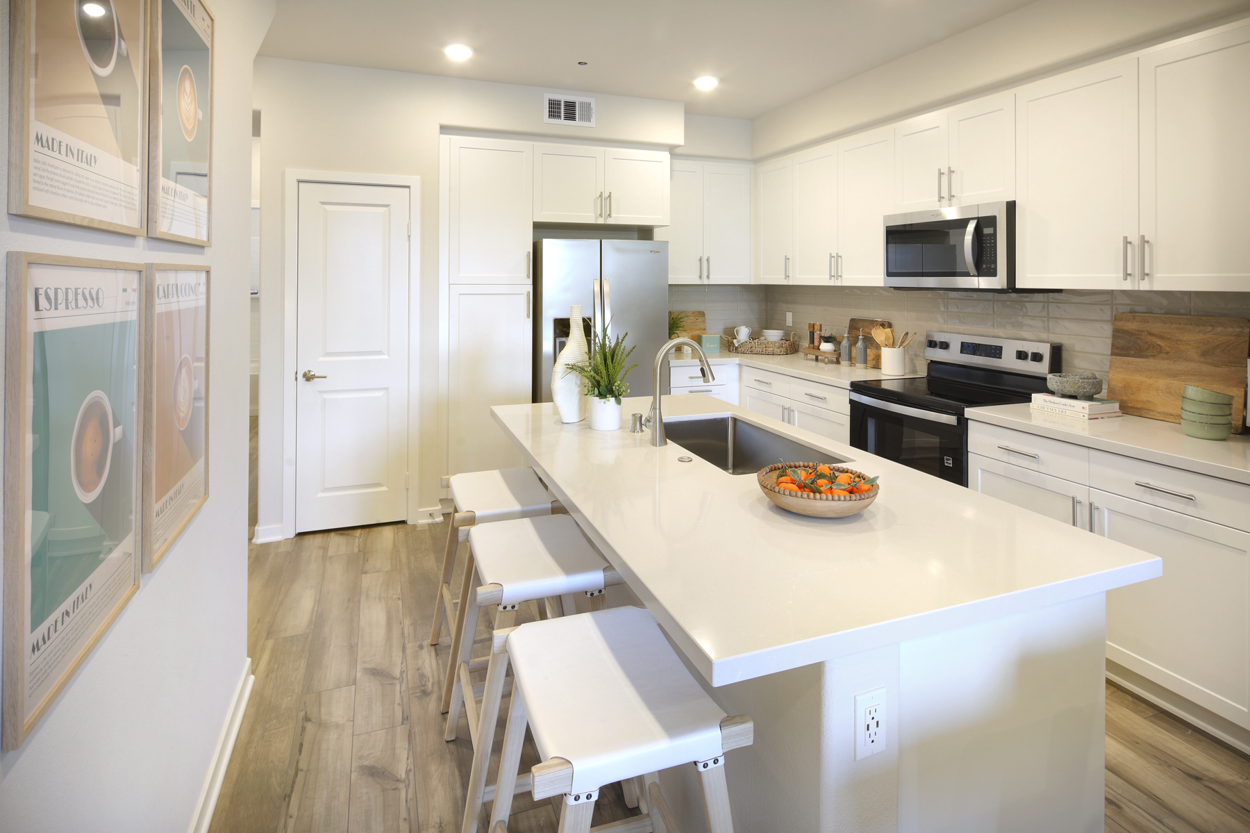 A kitchen with white cabinets.