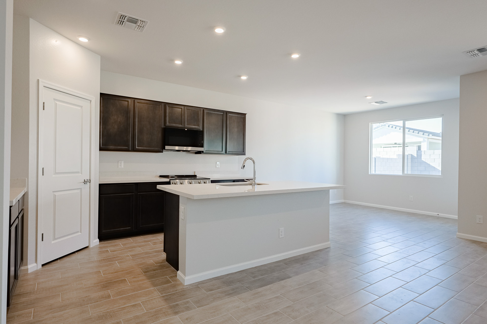 A kitchen with black cabinets.