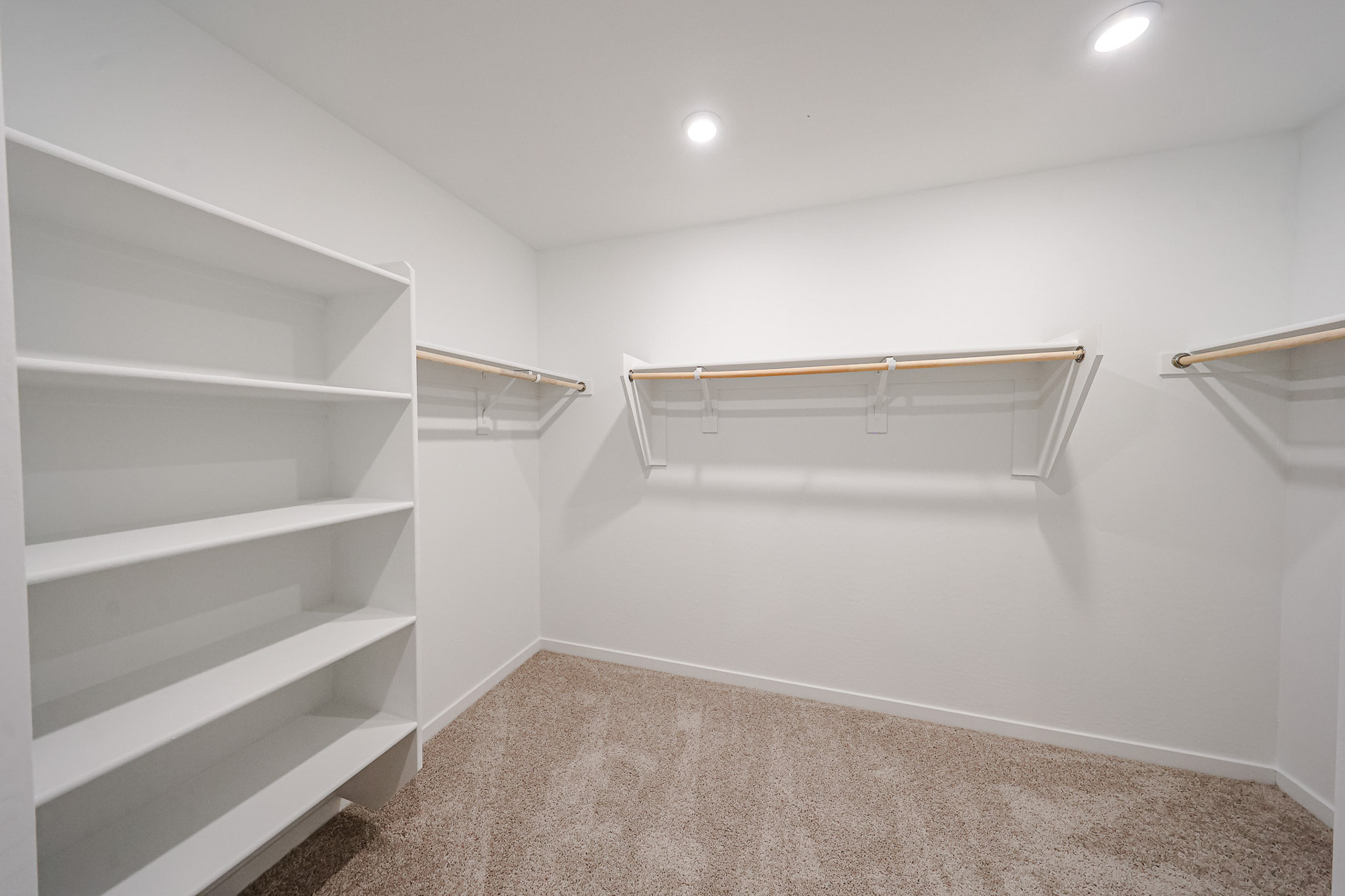 A white room with a white shelf.