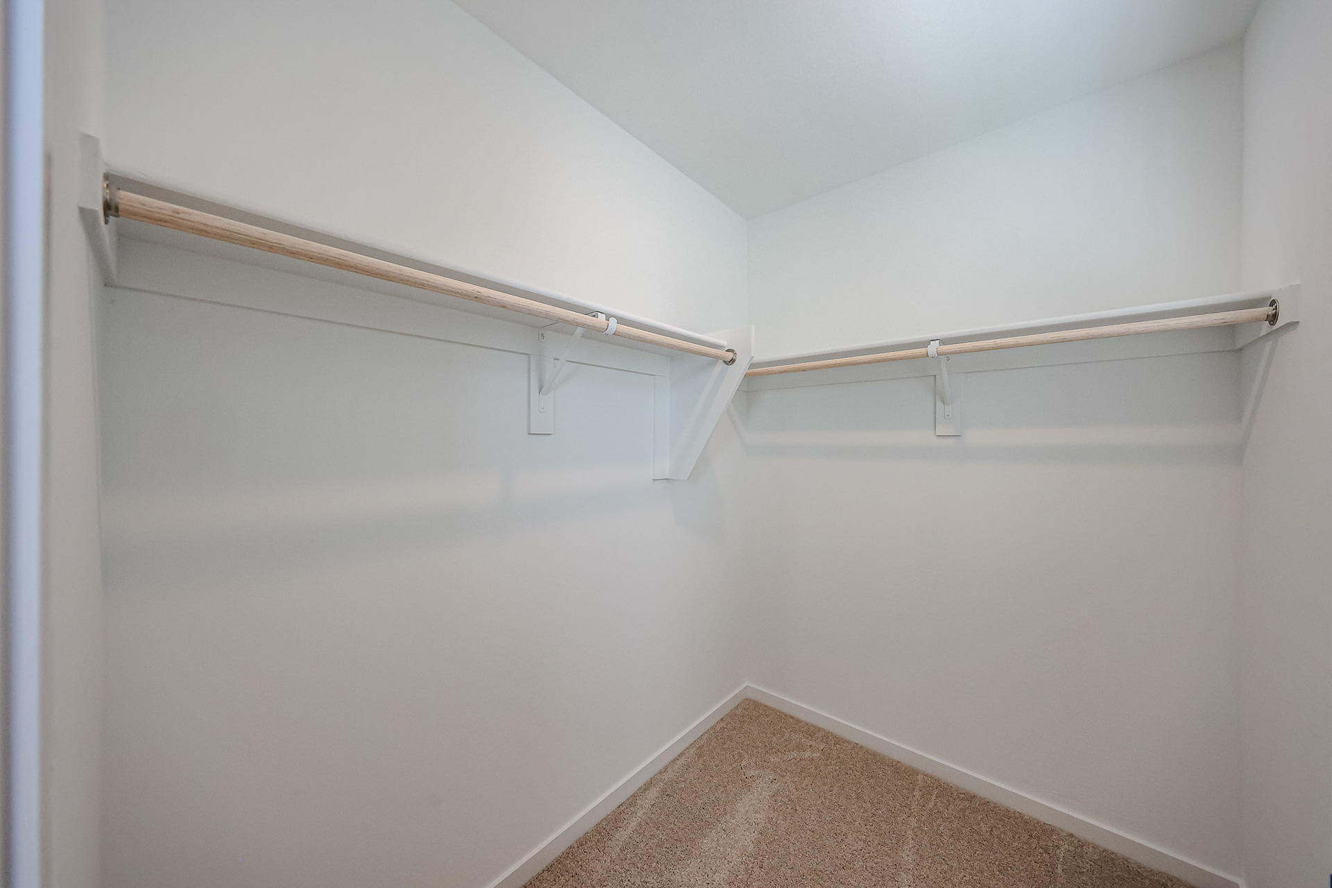 A white wall with a metal bar.