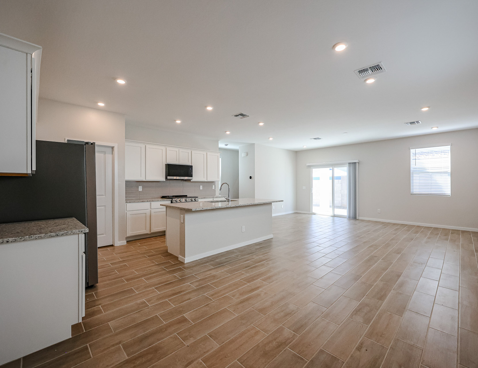 A large kitchen with white cabinets.