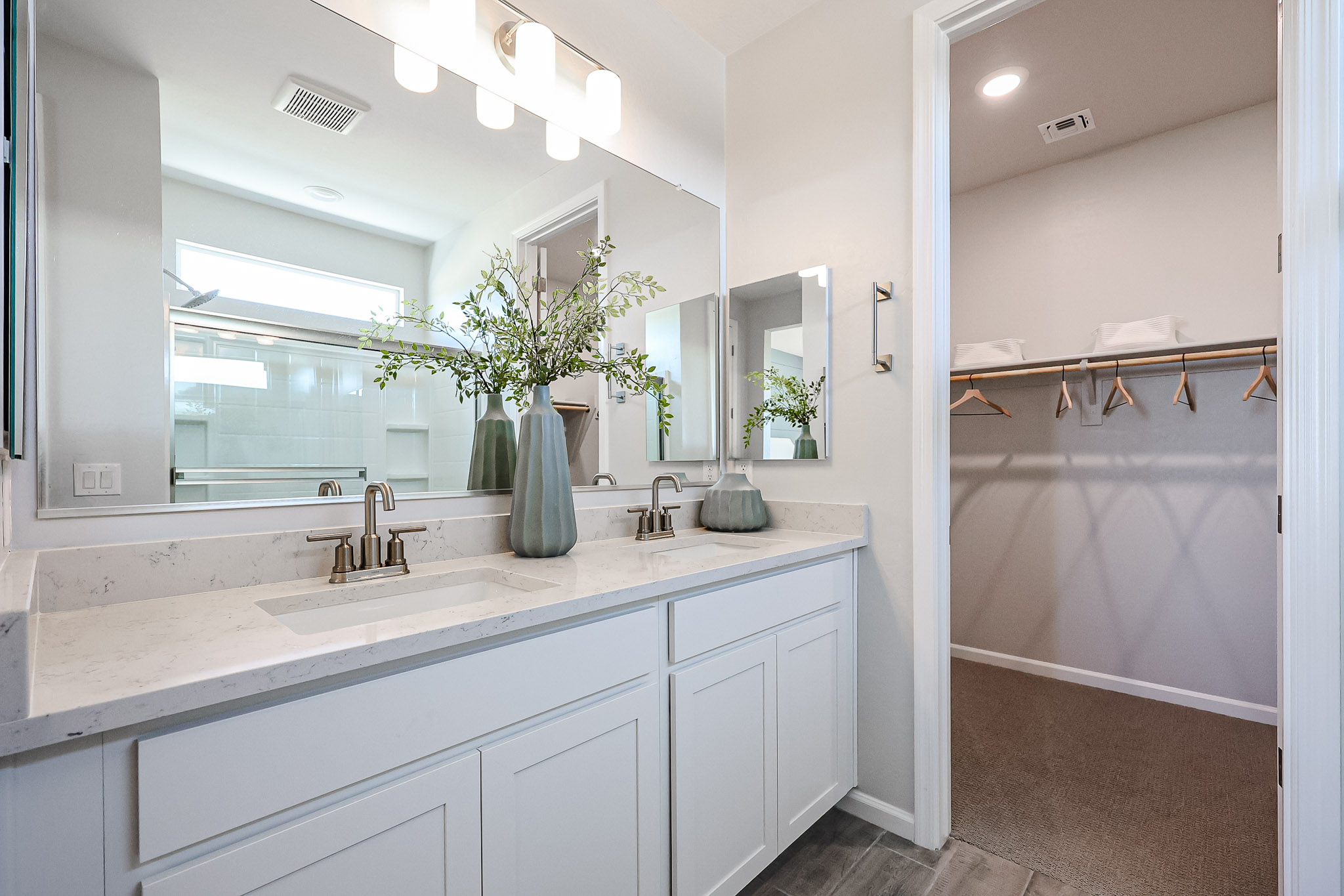 A bathroom with a large mirror.