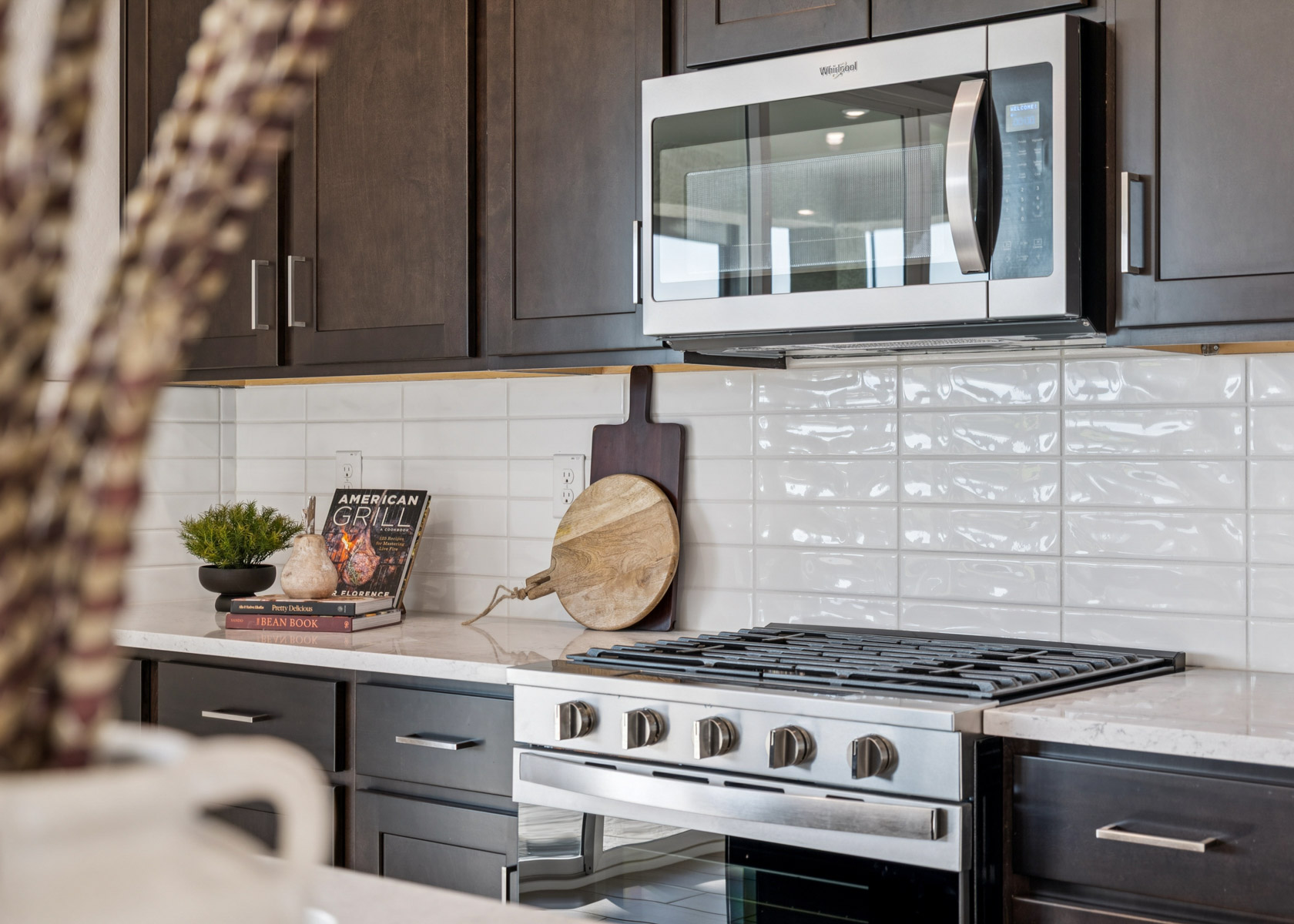 A kitchen with a microwave oven and a wood stove.