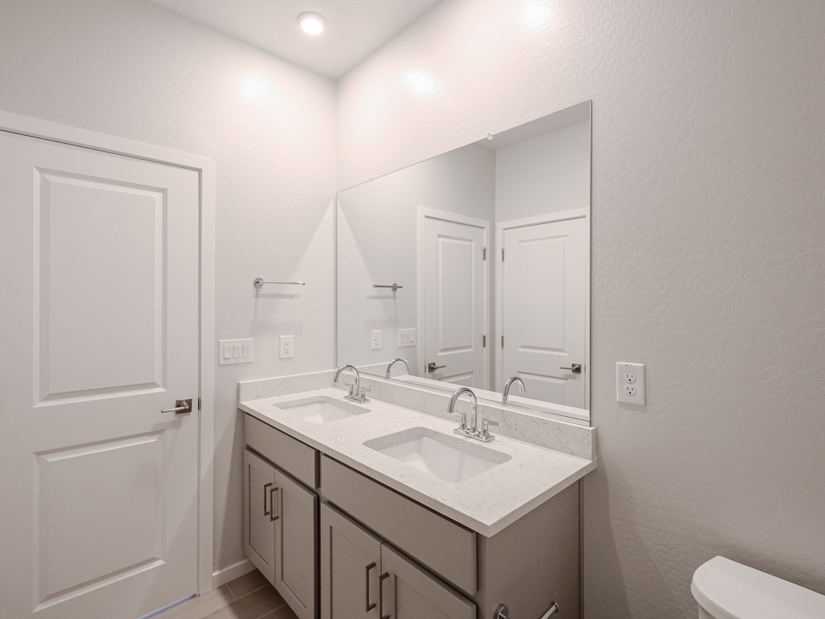 A bathroom with a large mirror.