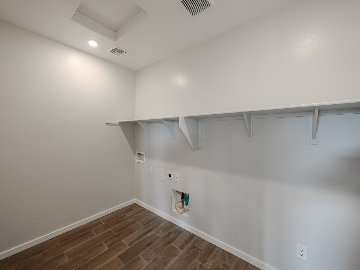 A white room with a wood floor.