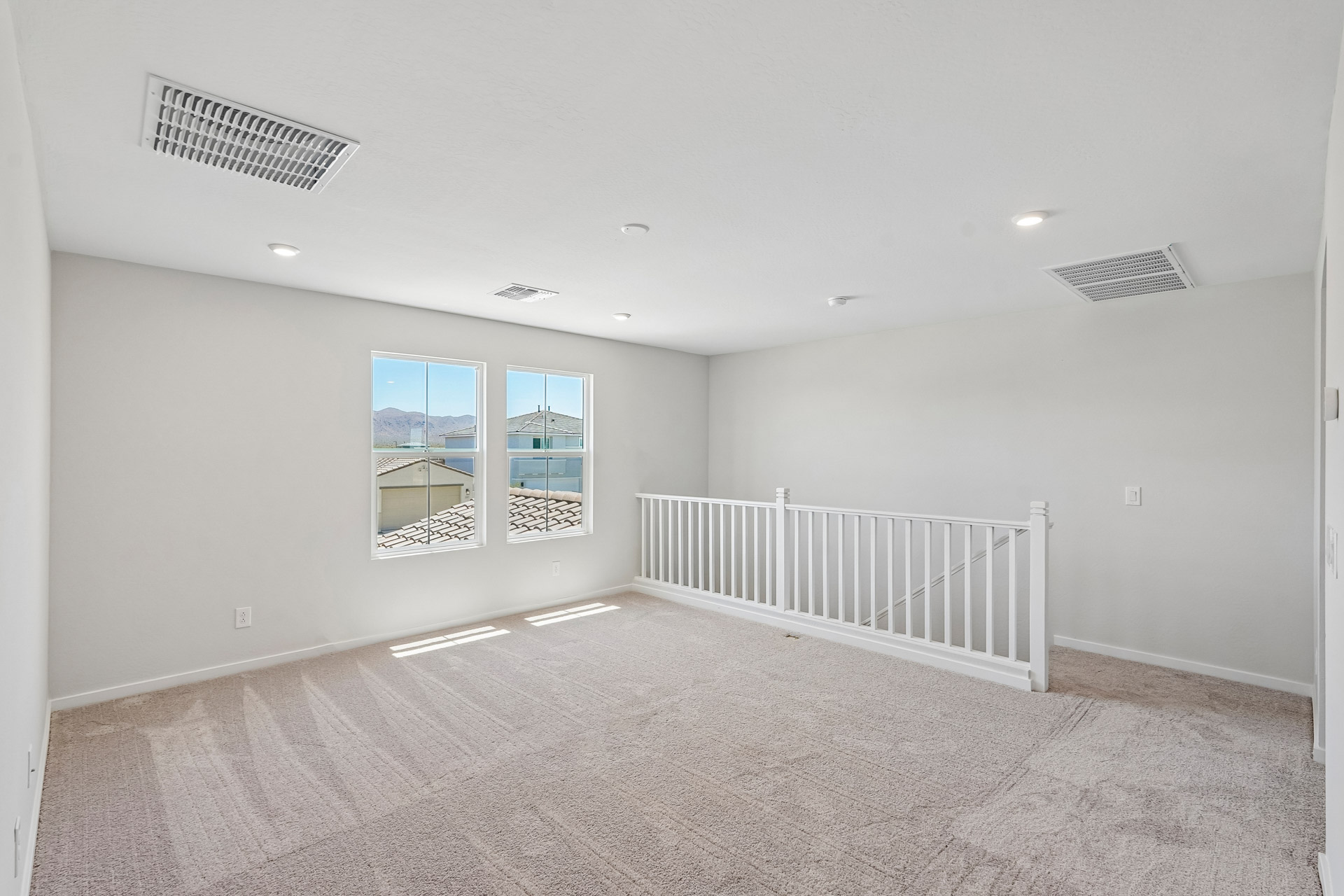 A room with a white railing and a white railing.