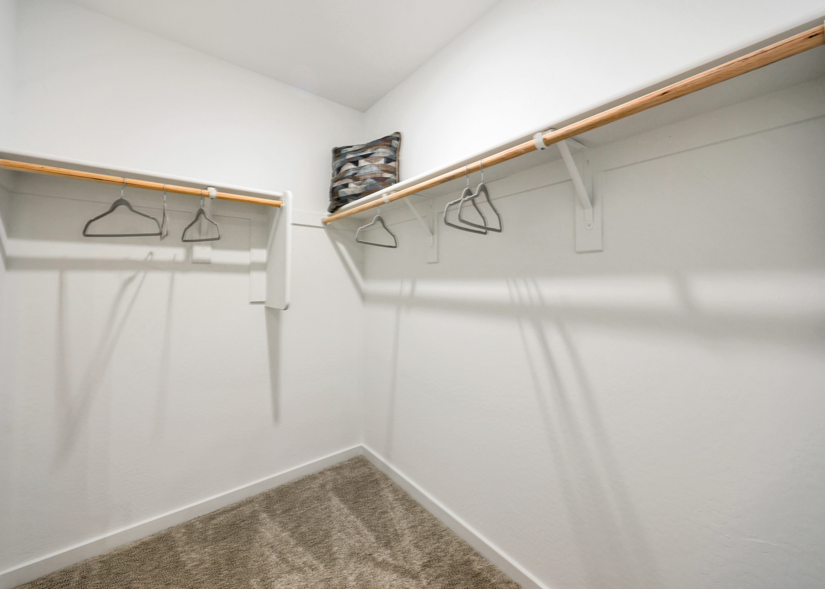 A white shower with a metal bar.