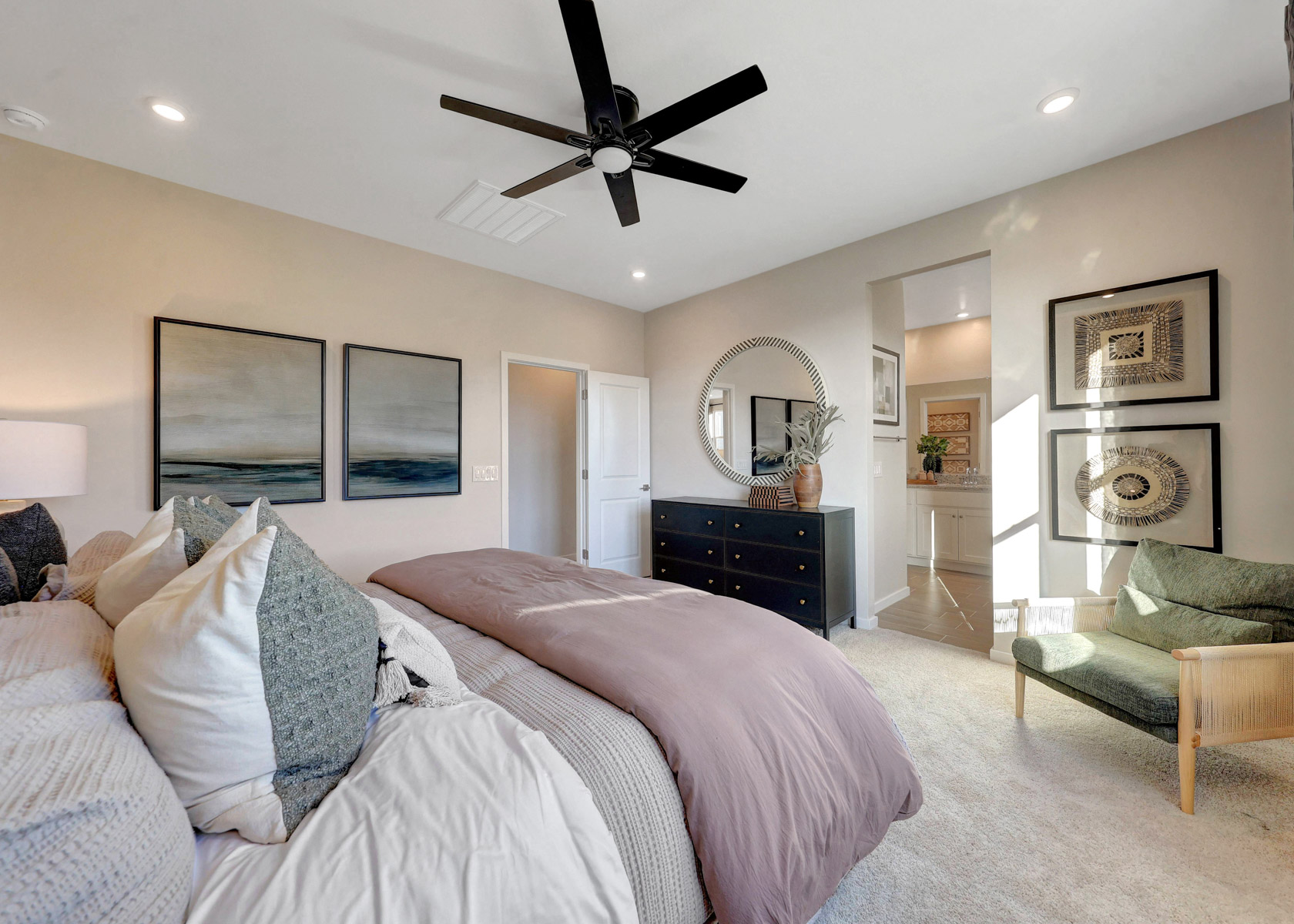 A bedroom with a fan and a bed.