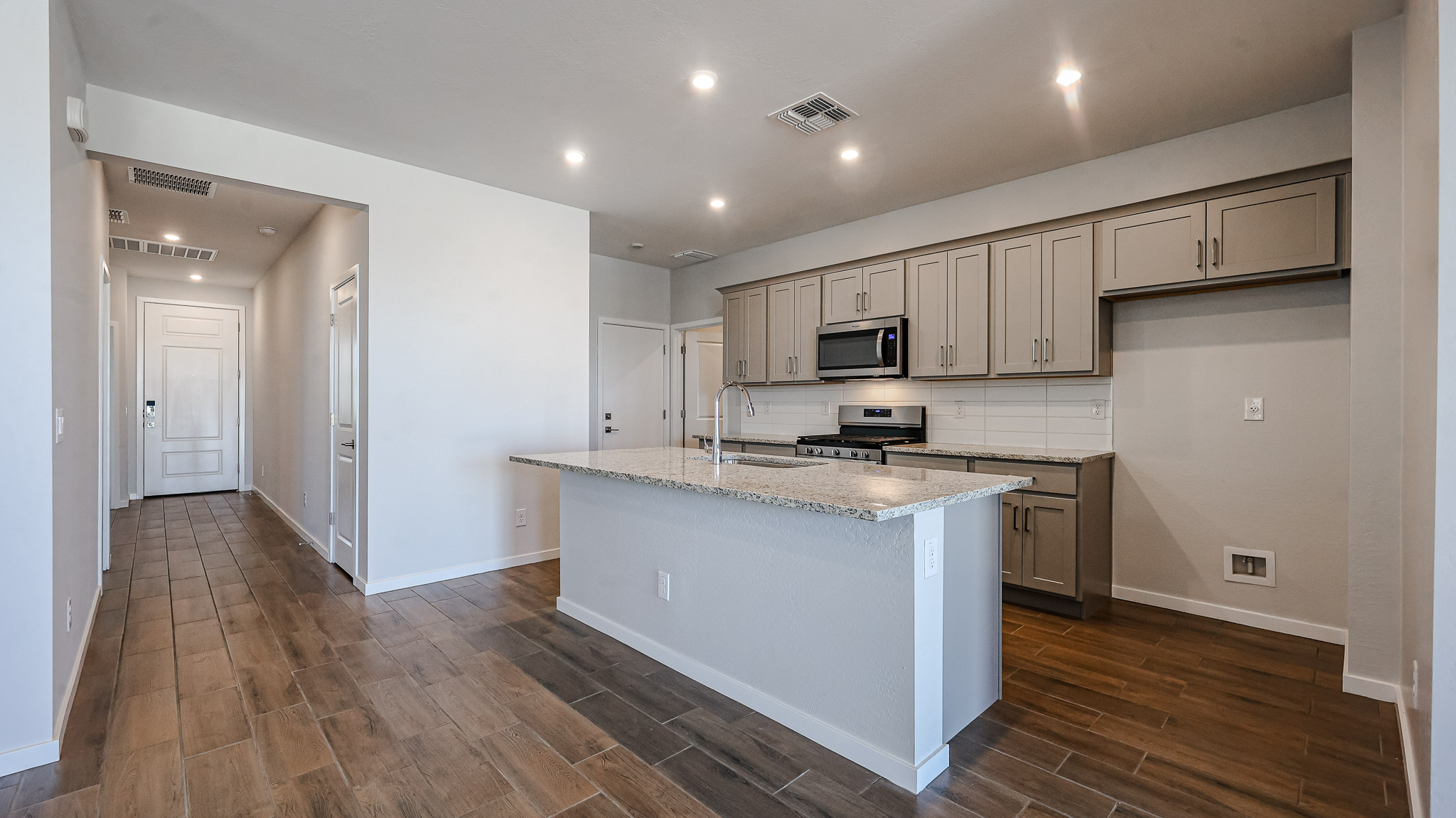 A kitchen with white cabinets.