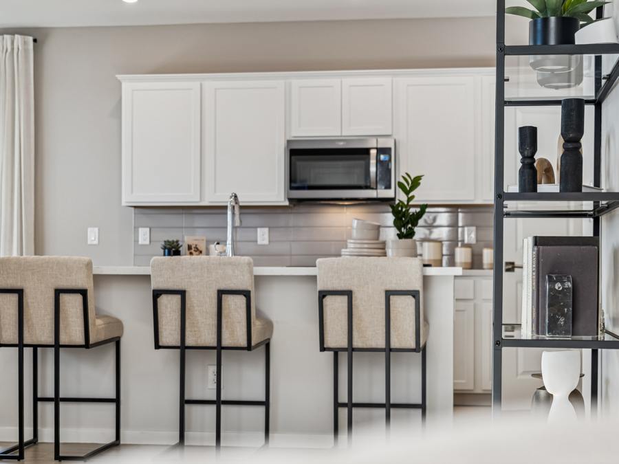 A kitchen with white cabinets.