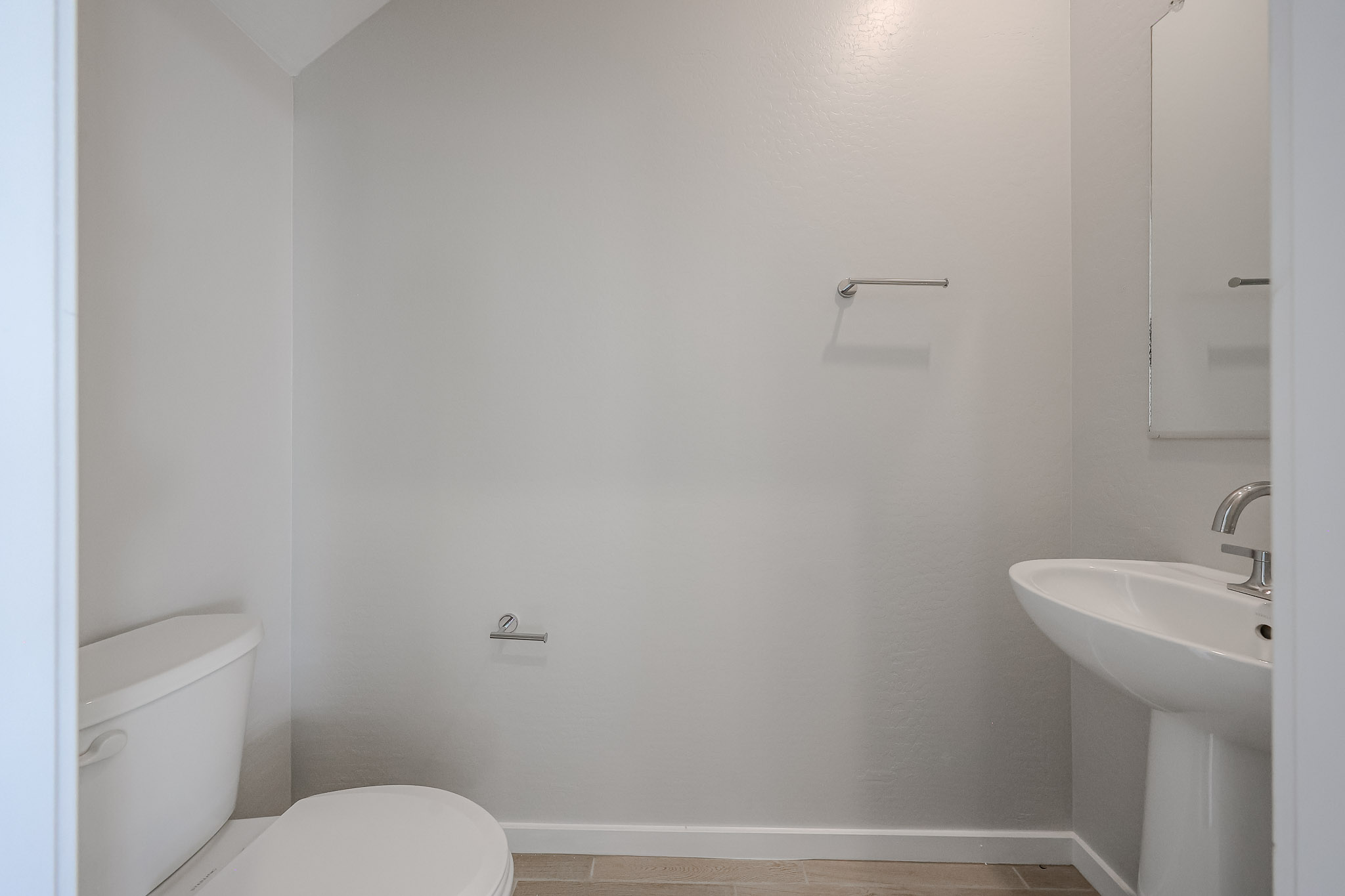 A bathroom with a toilet and sink.