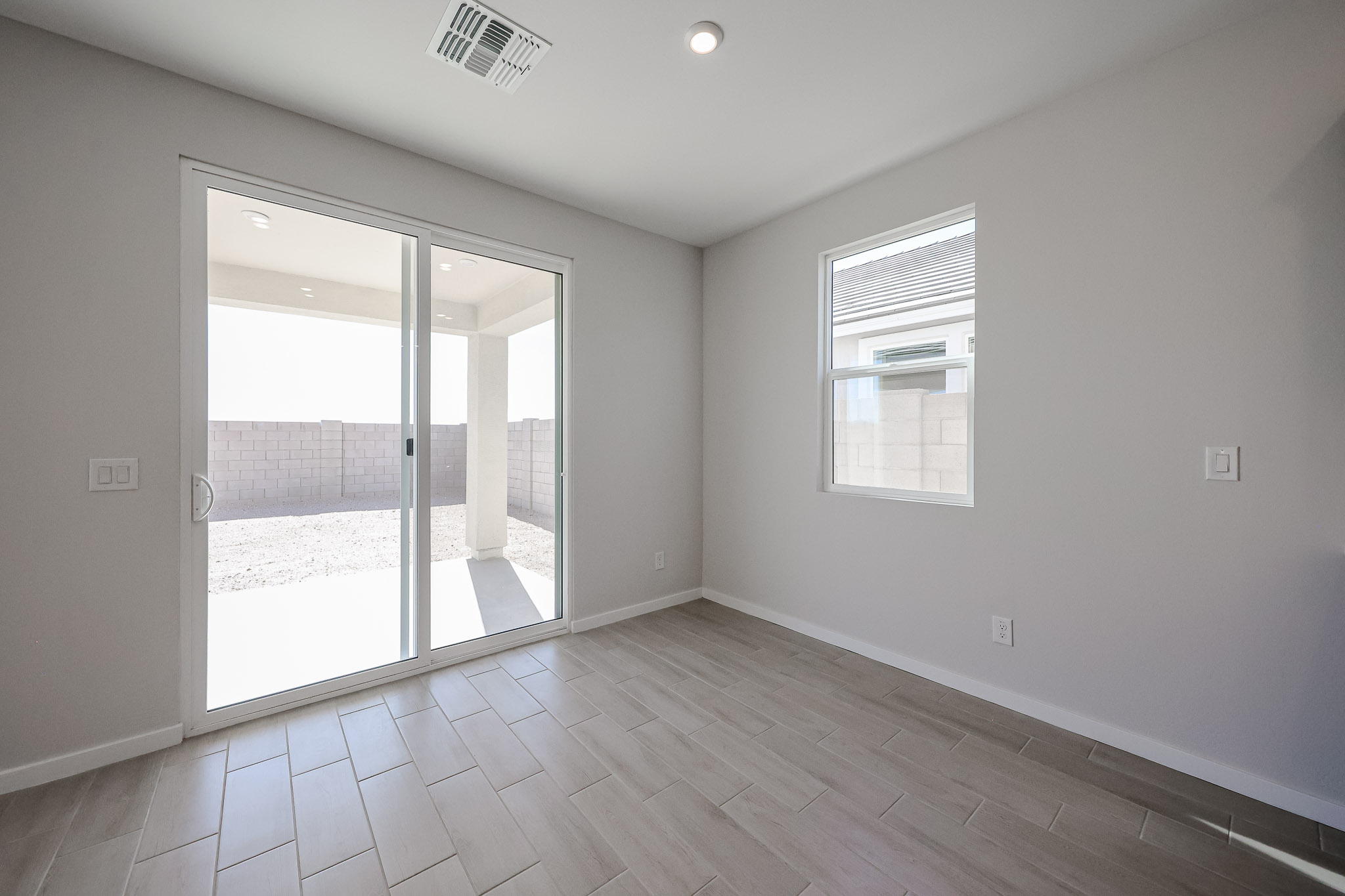 A room with a glass door and a wood floor.