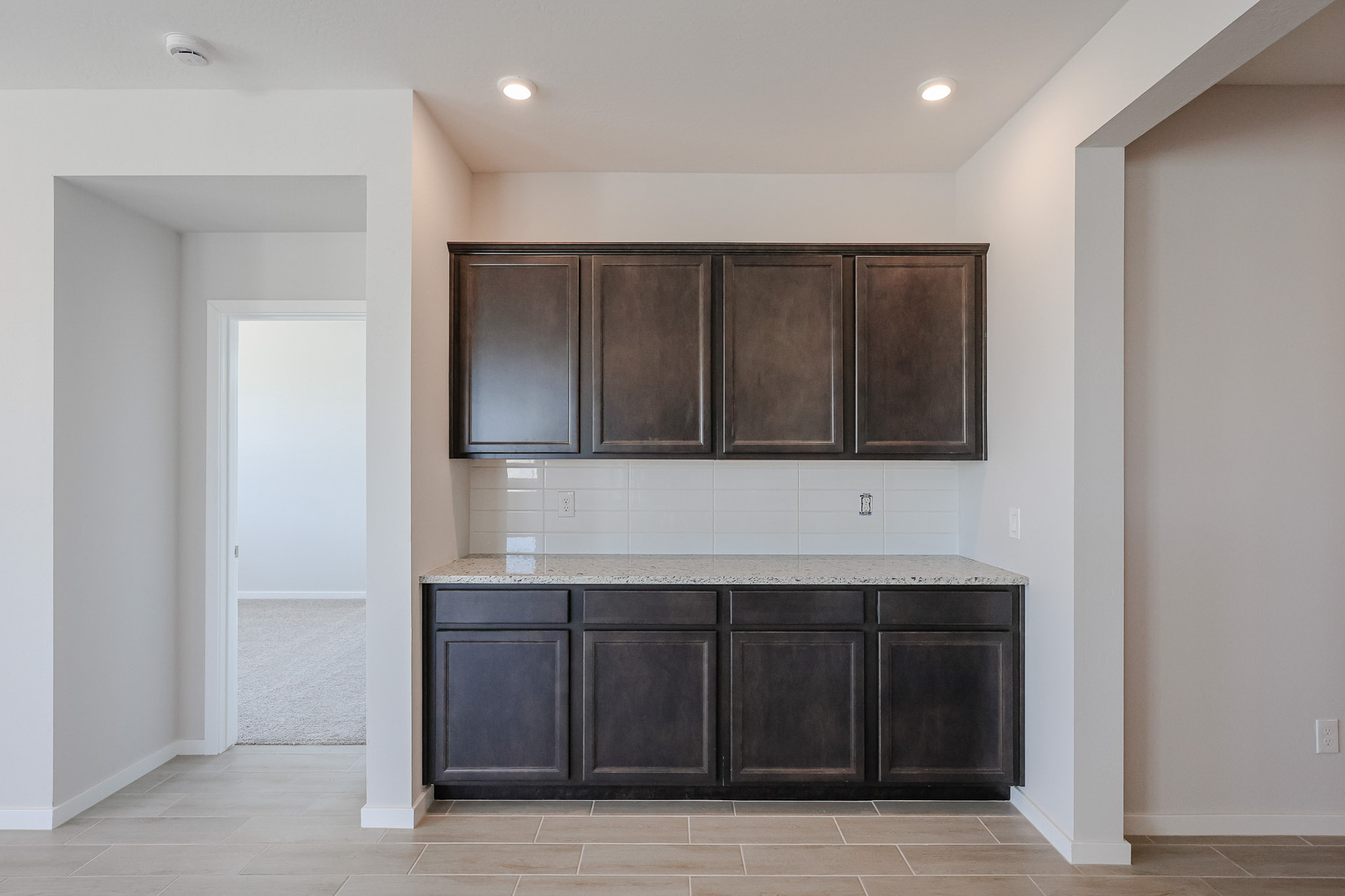 A kitchen with black cabinets.