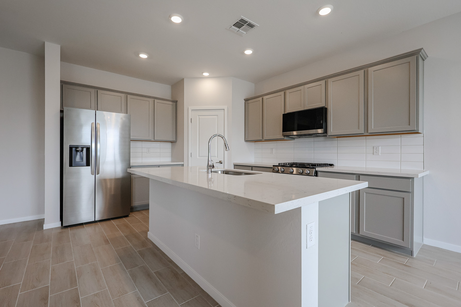 A kitchen with white cabinets.