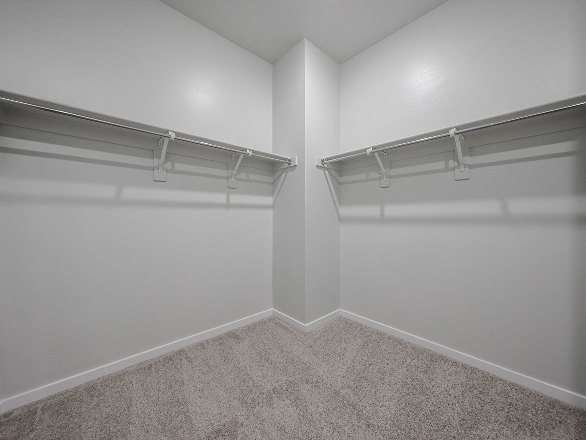 A white wall with a metal railing.