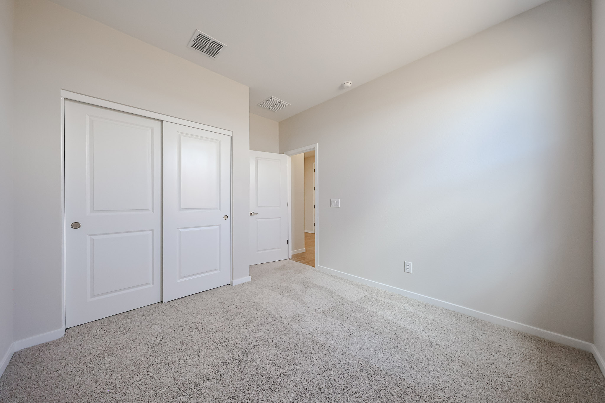 A hallway with white doors.