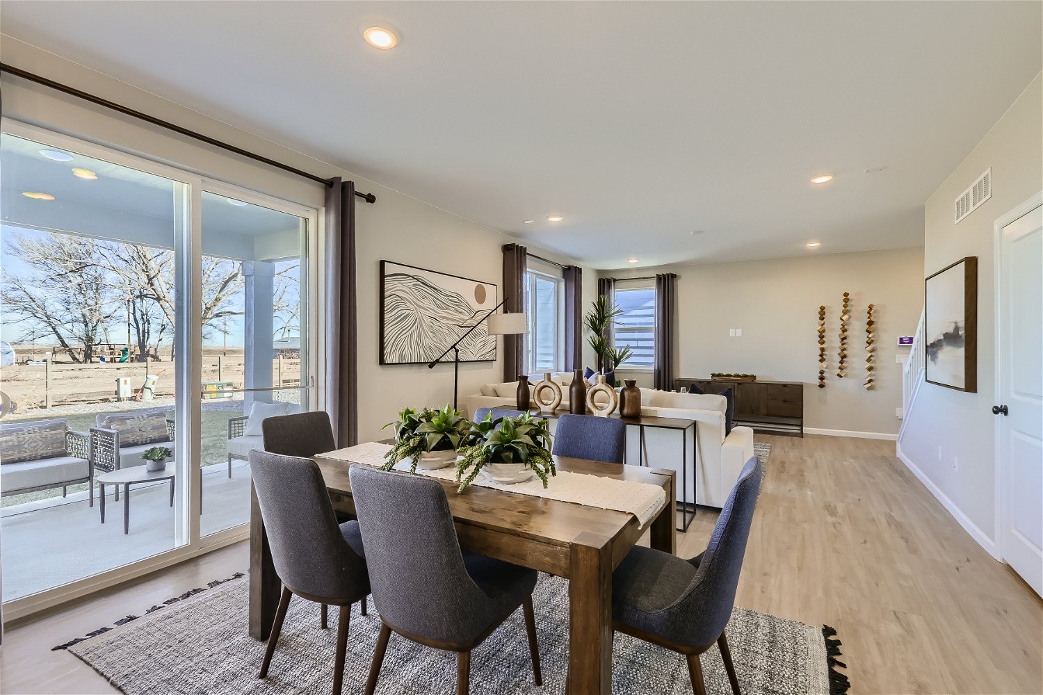A dining room with a large glass door.