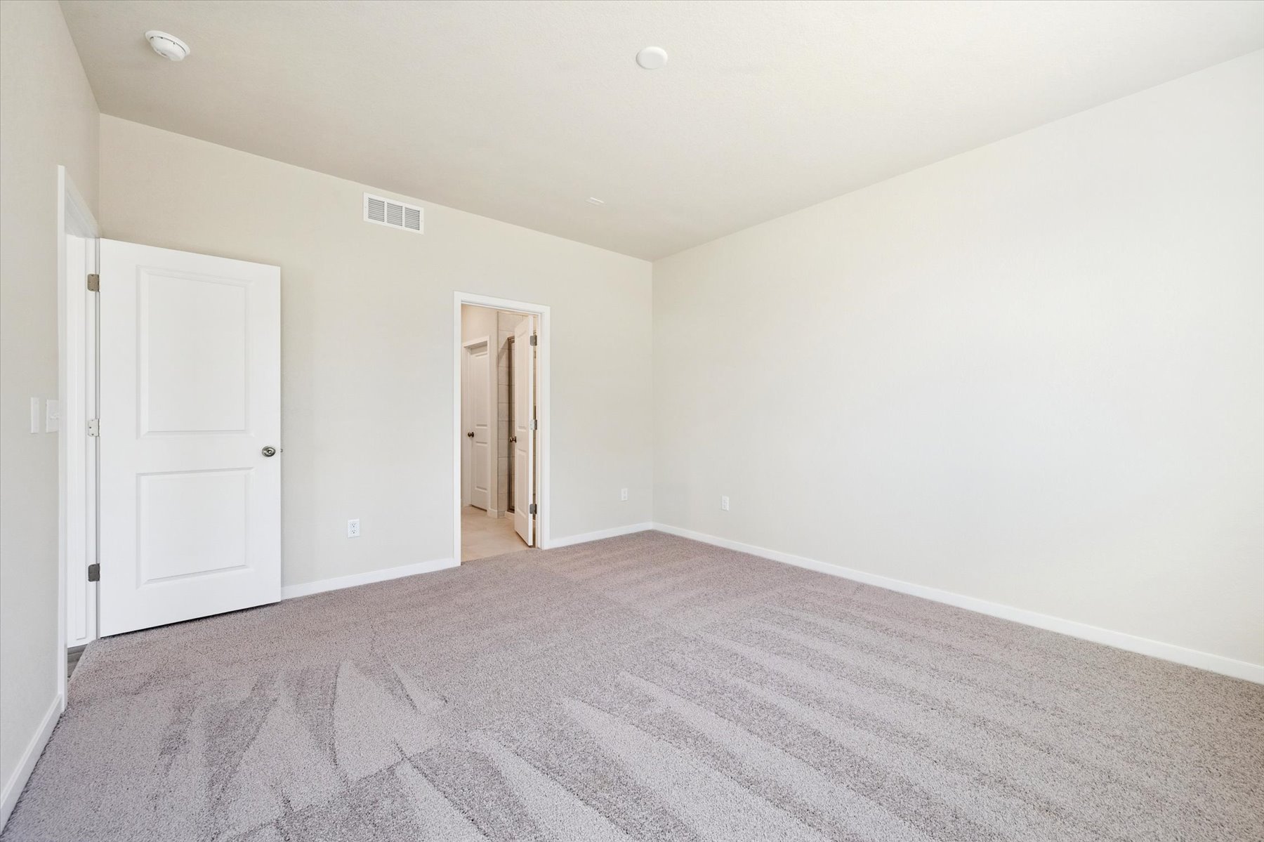 A hallway with white doors.