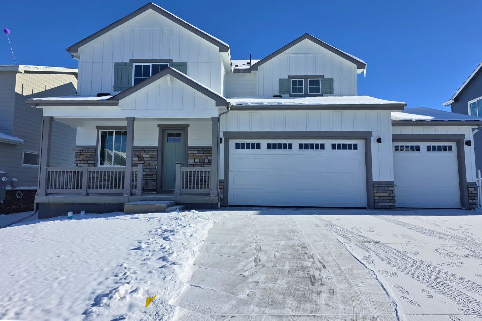 A building with a garage and snow.