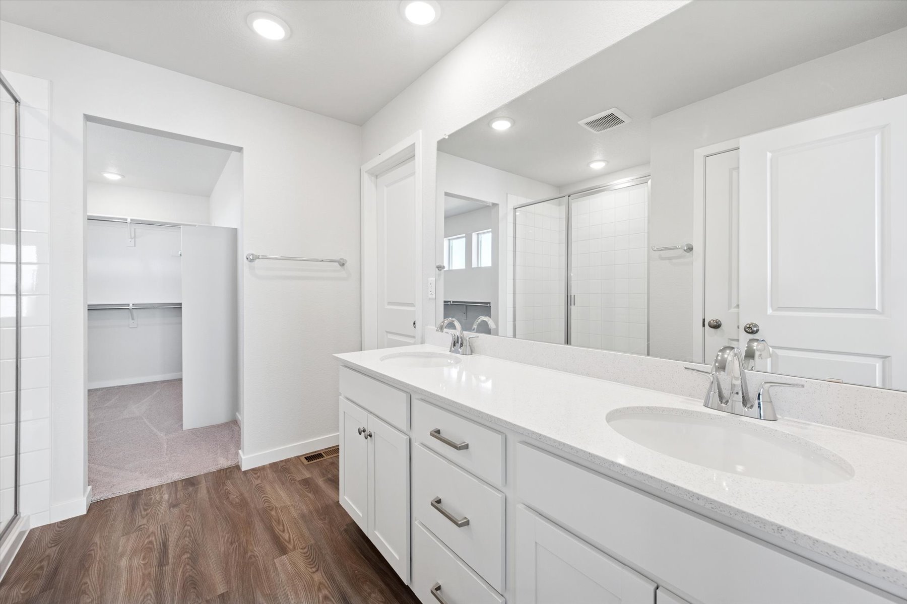 A bathroom with a large mirror.