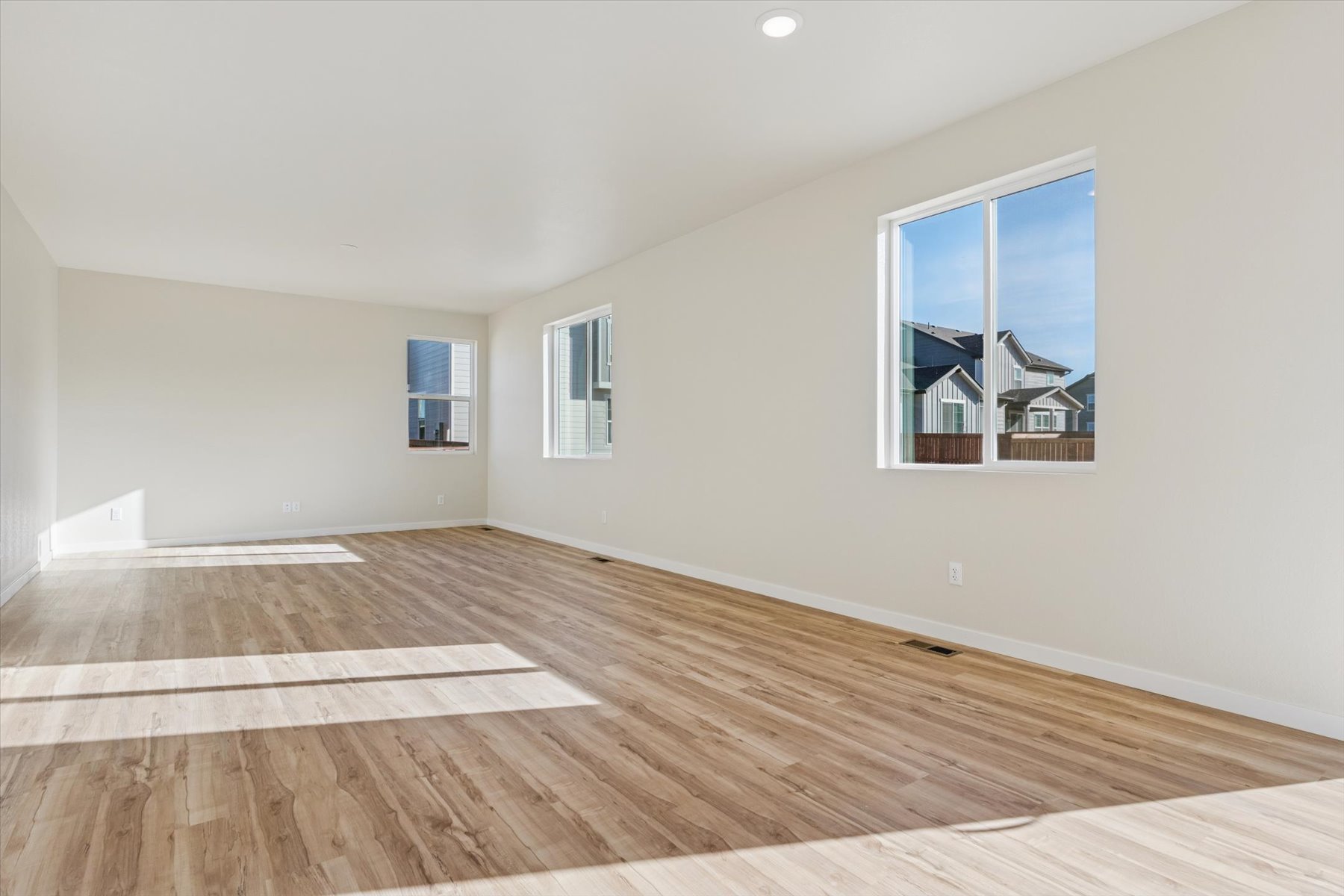 A room with a wood floor and a wood floor with a painting on the wall.
