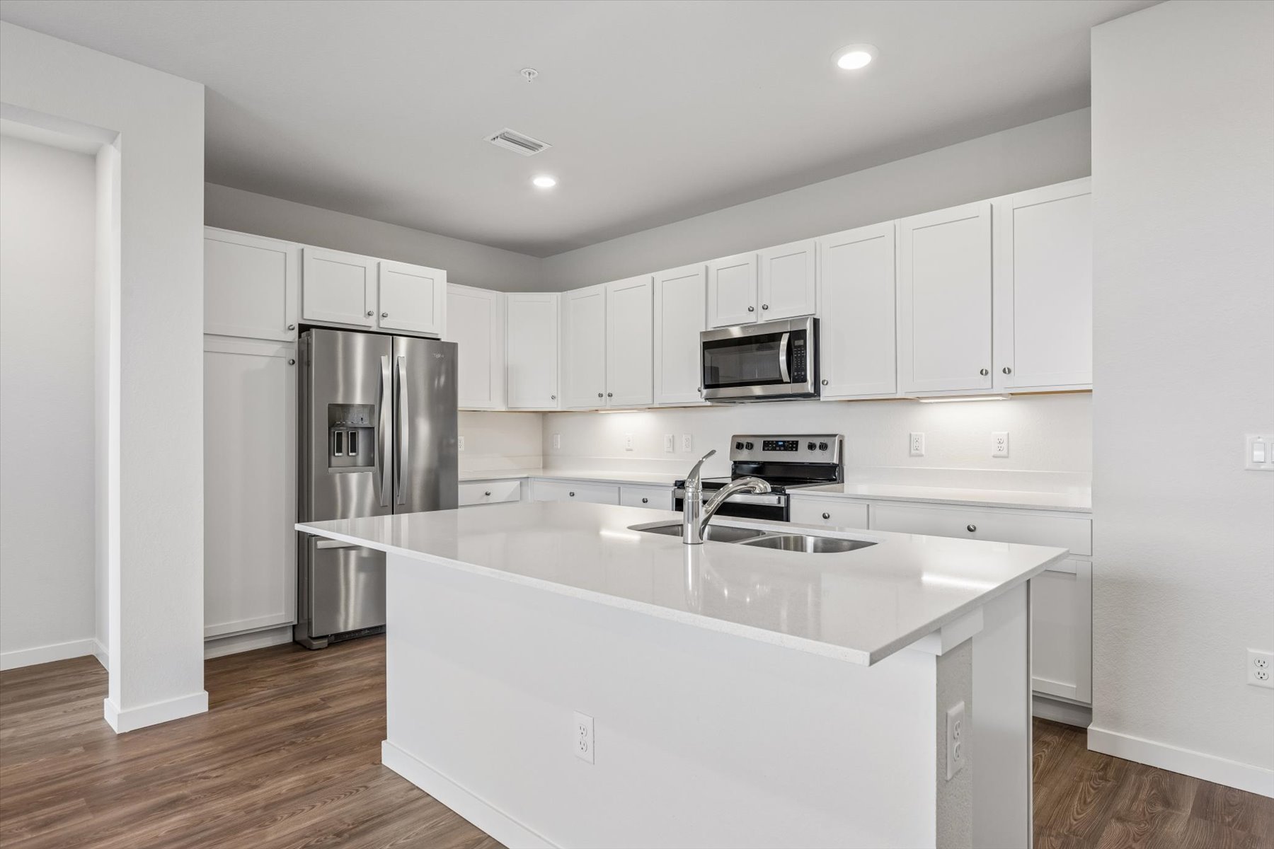 A kitchen with white cabinets.