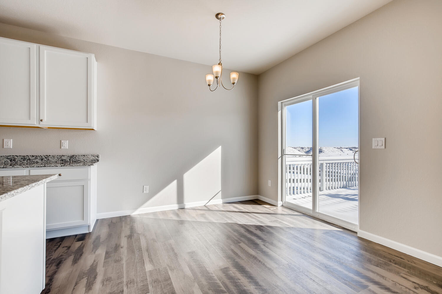 A kitchen with a glass door.