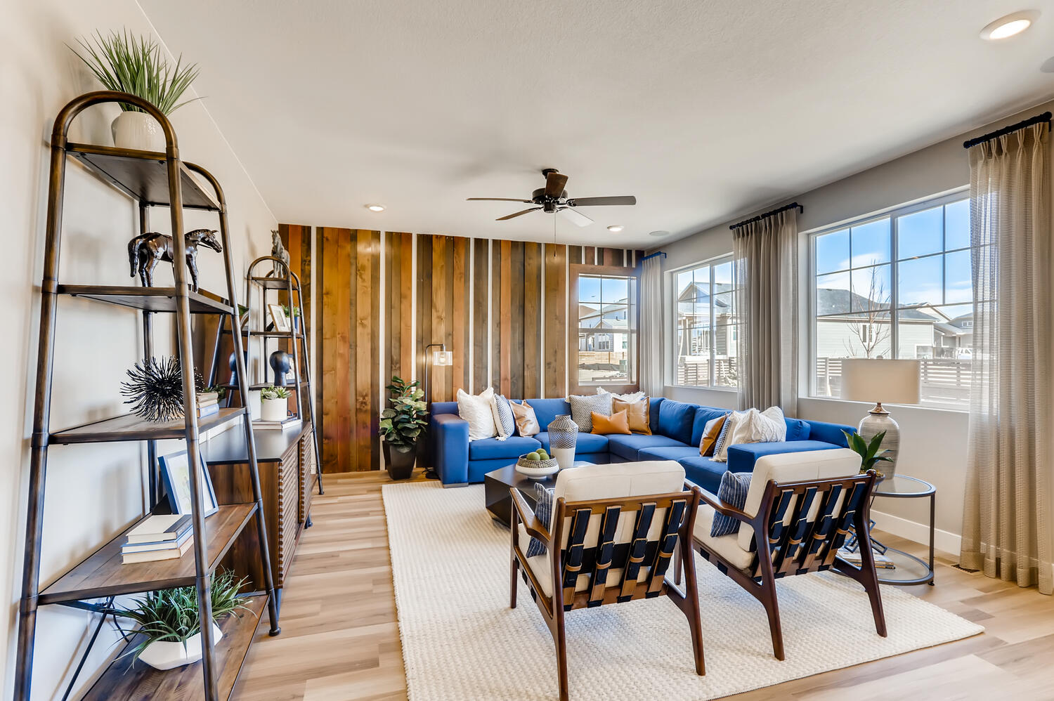 A living room with a blue couch and a table.