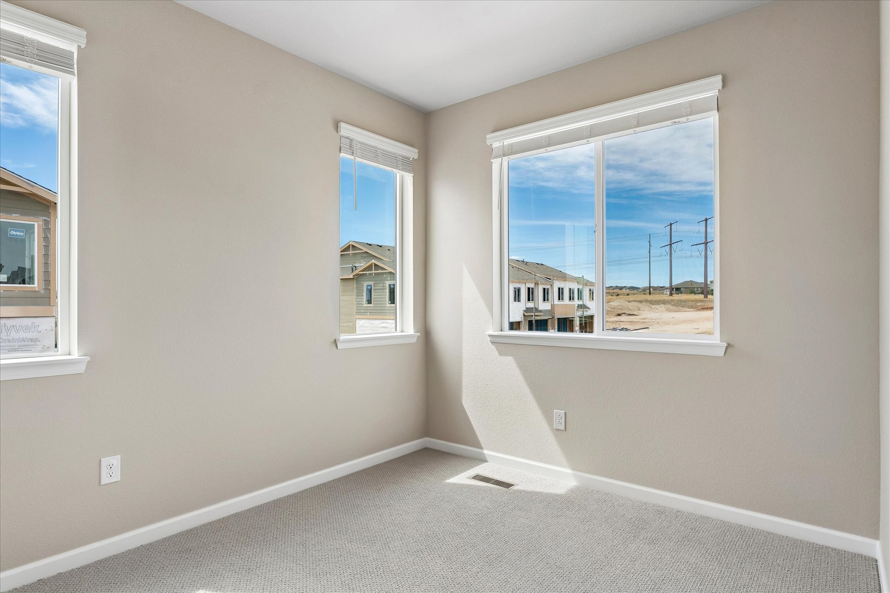 A room with a window and a view of the ocean.
