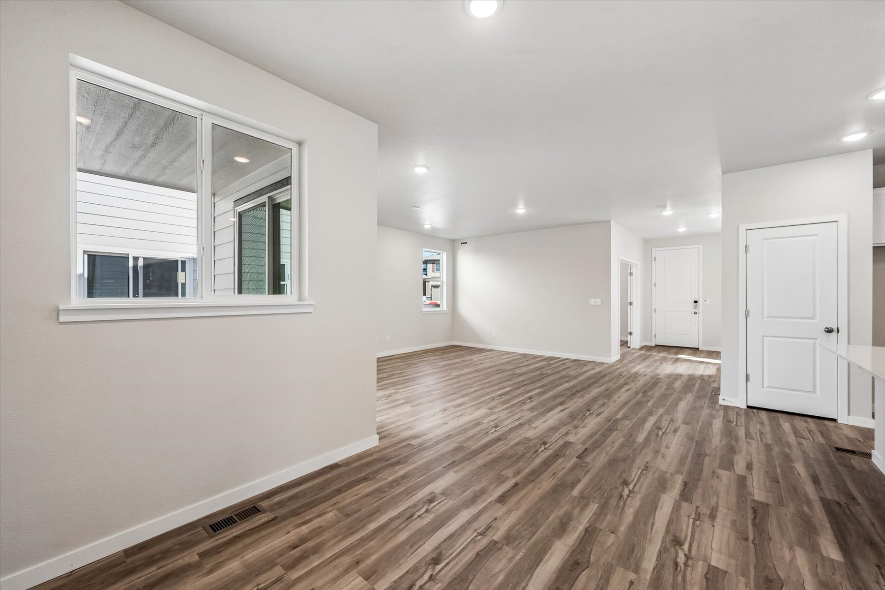 A room with a wood floor and a window.