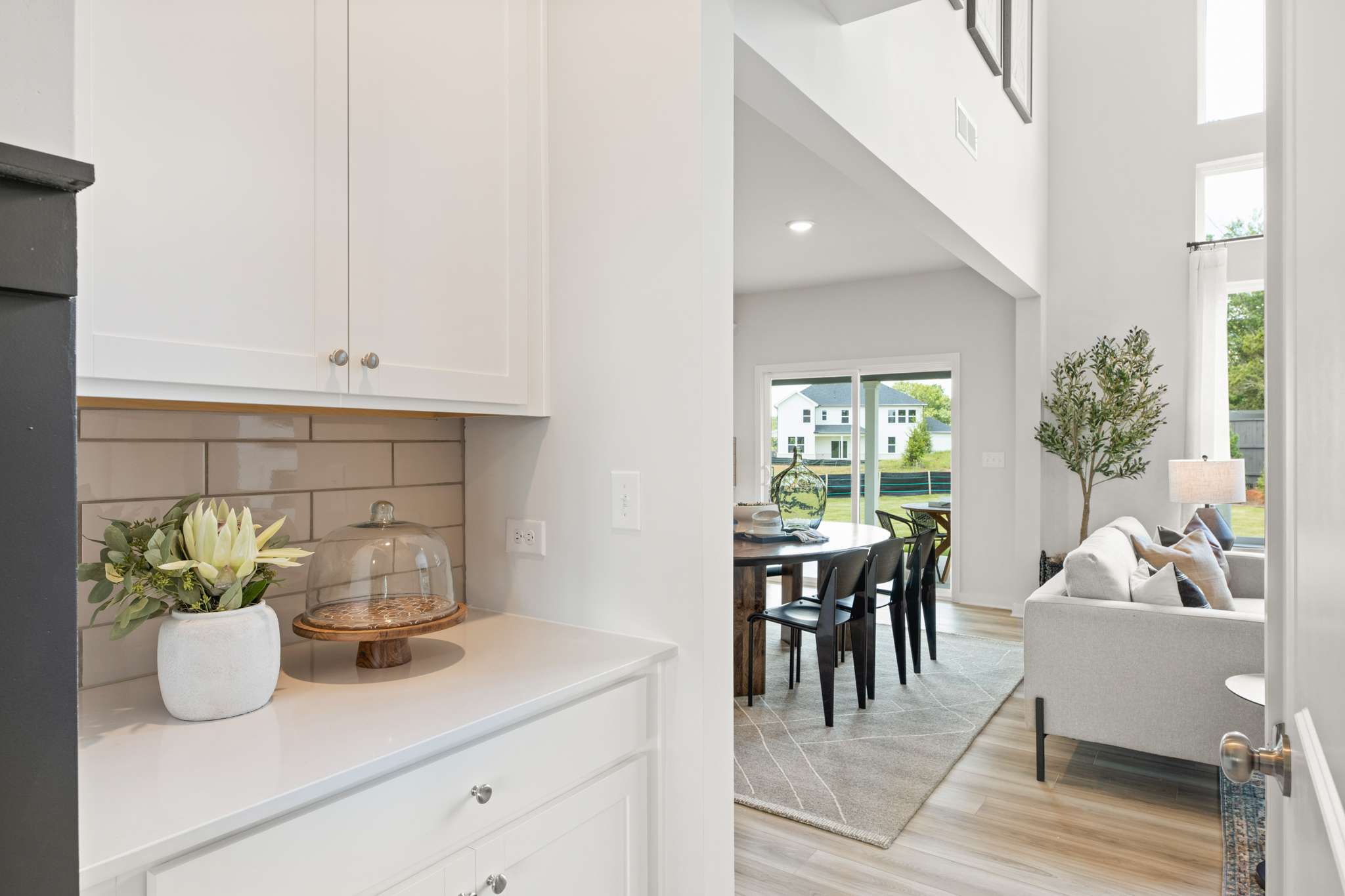 A person lying on a couch in a living room.
