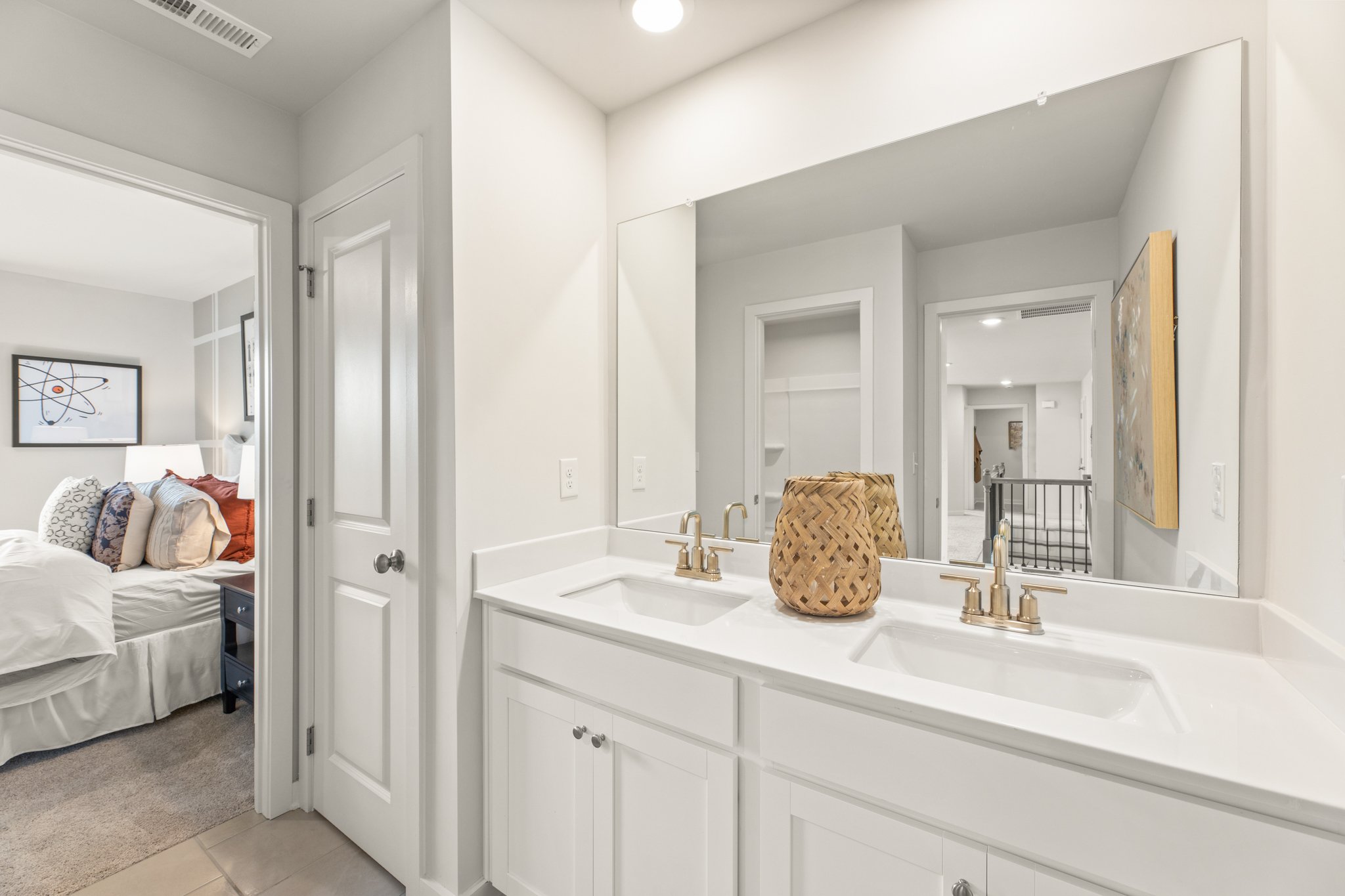 A bathroom with a bed and sink.