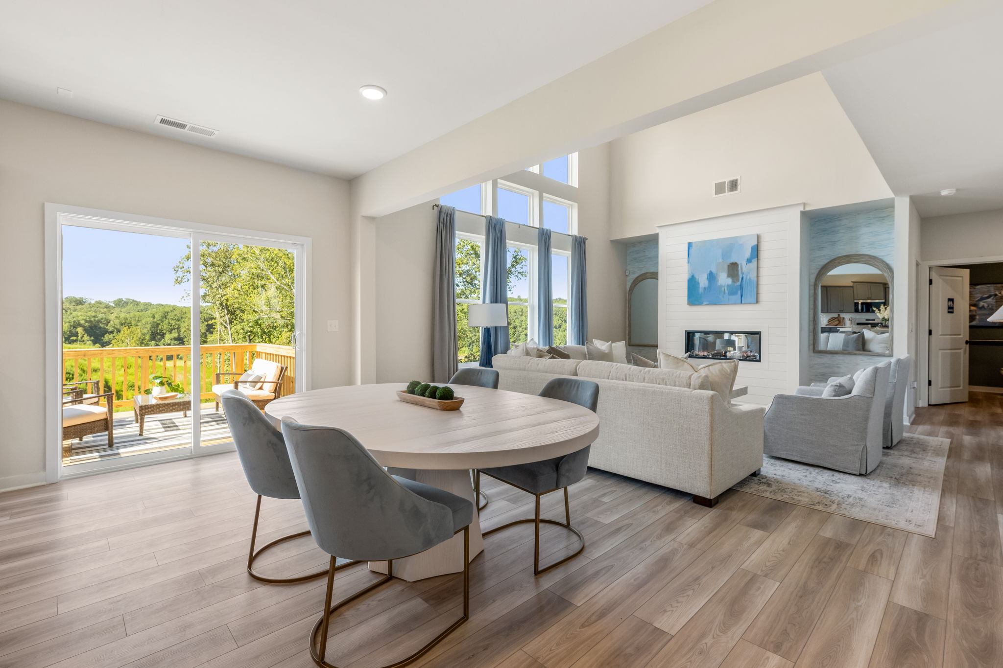 A living room with a table and chairs.