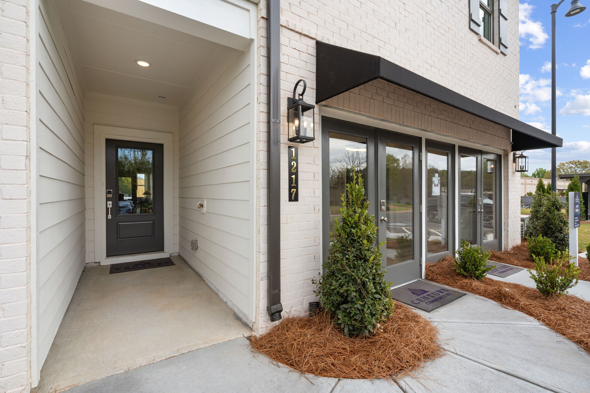 A building with a small tree in the front.