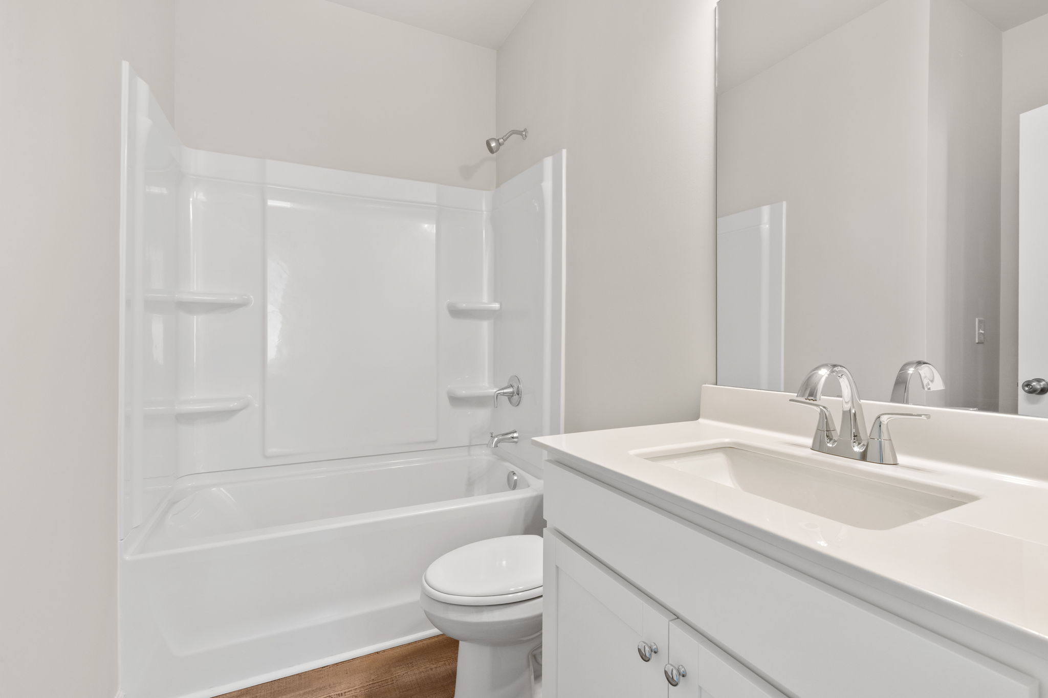 A bathroom with a tub sink and toilet.