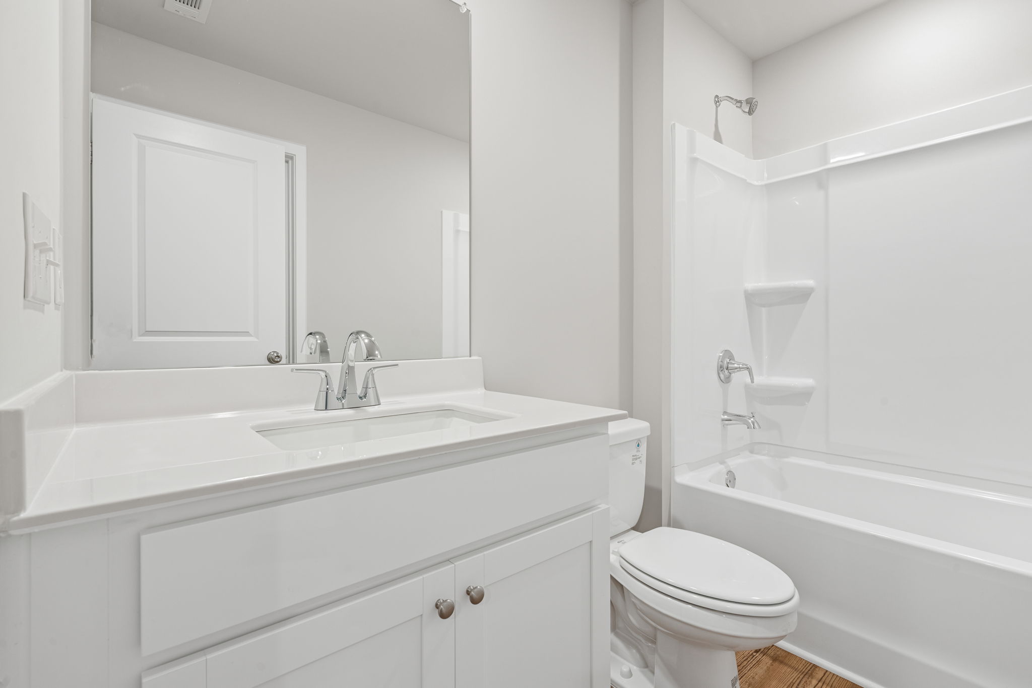 A bathroom with a tub sink and toilet.