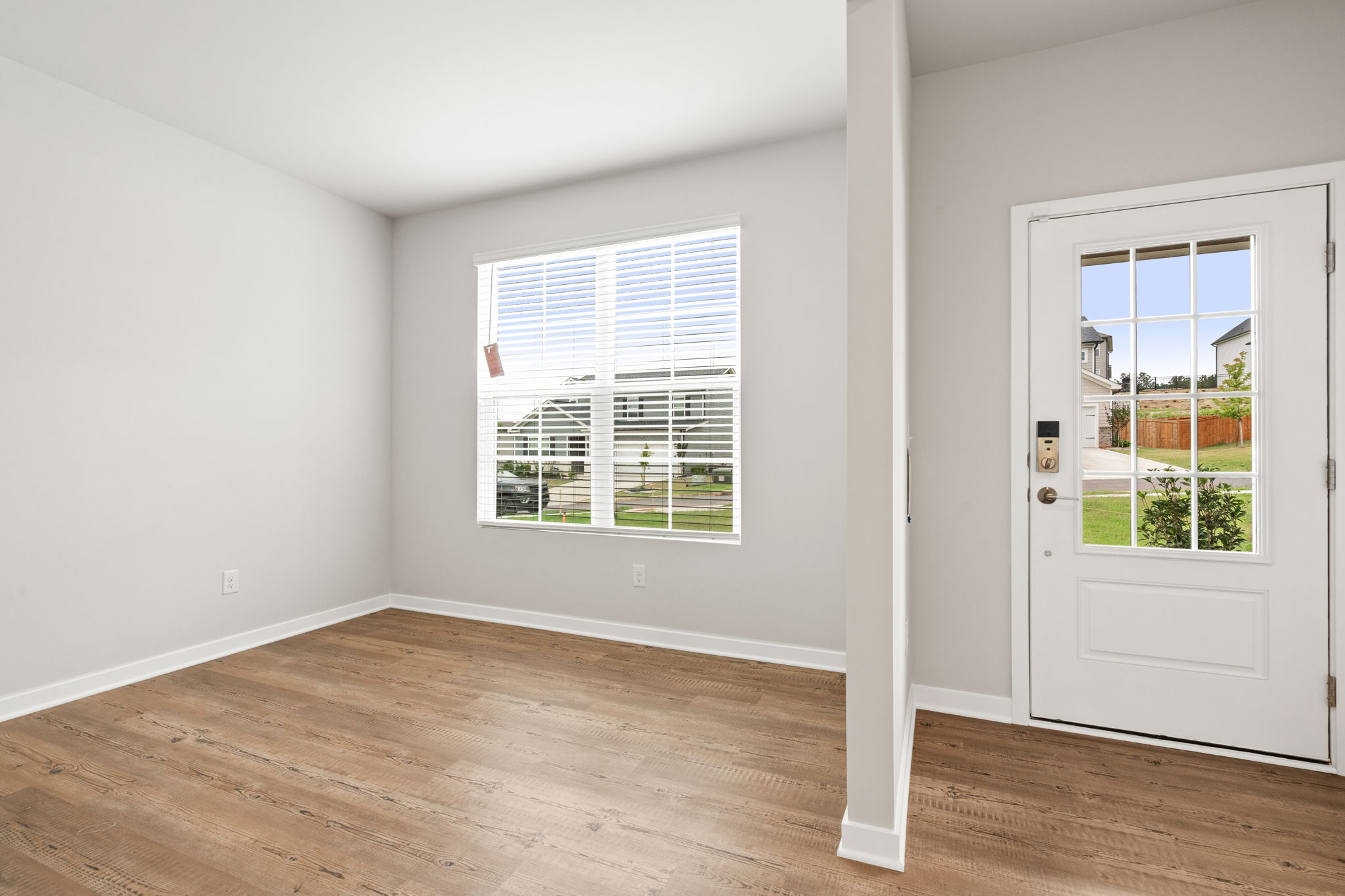 A room with a wood floor and windows.