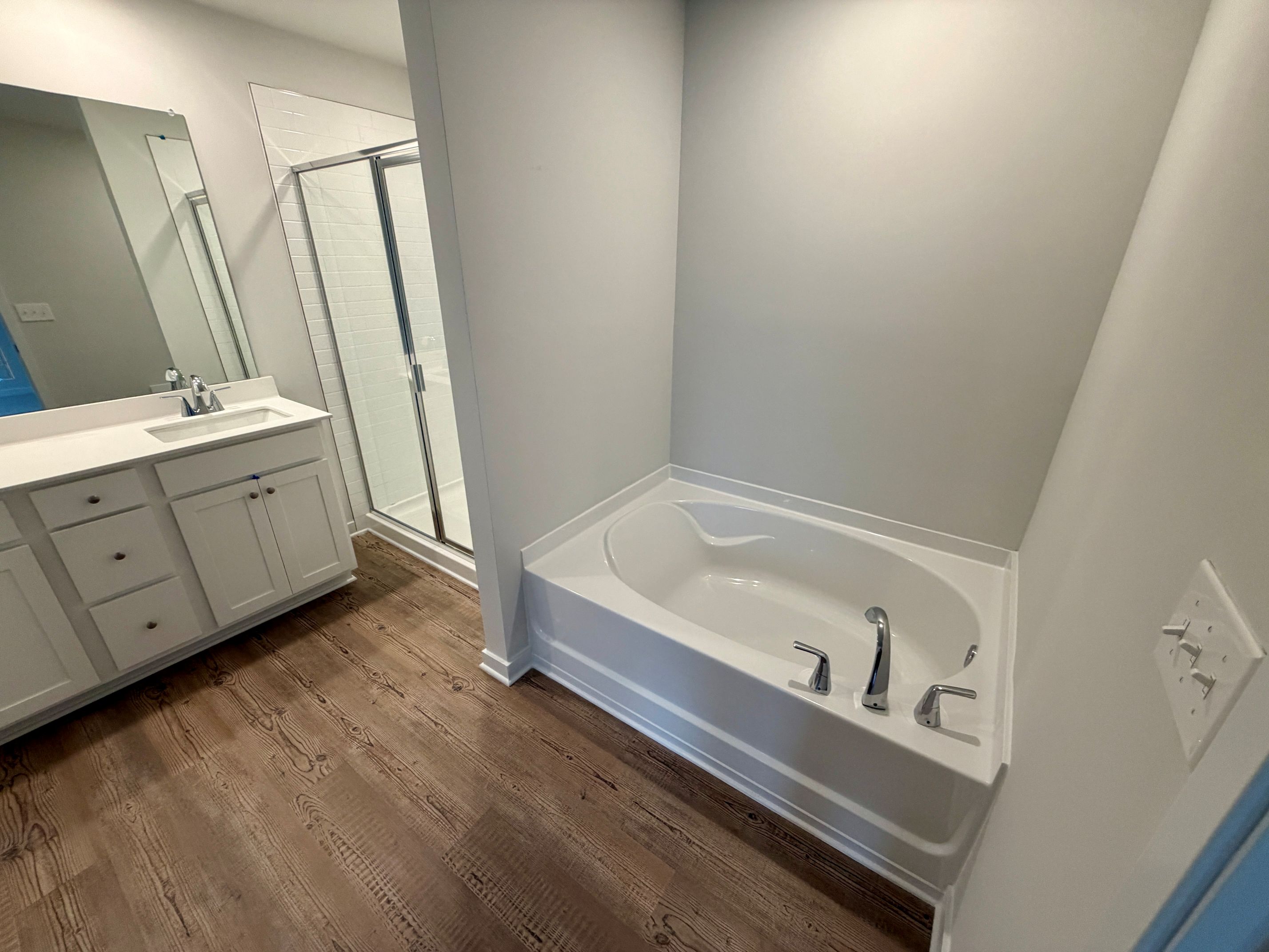 A bathroom with a tub and sink.