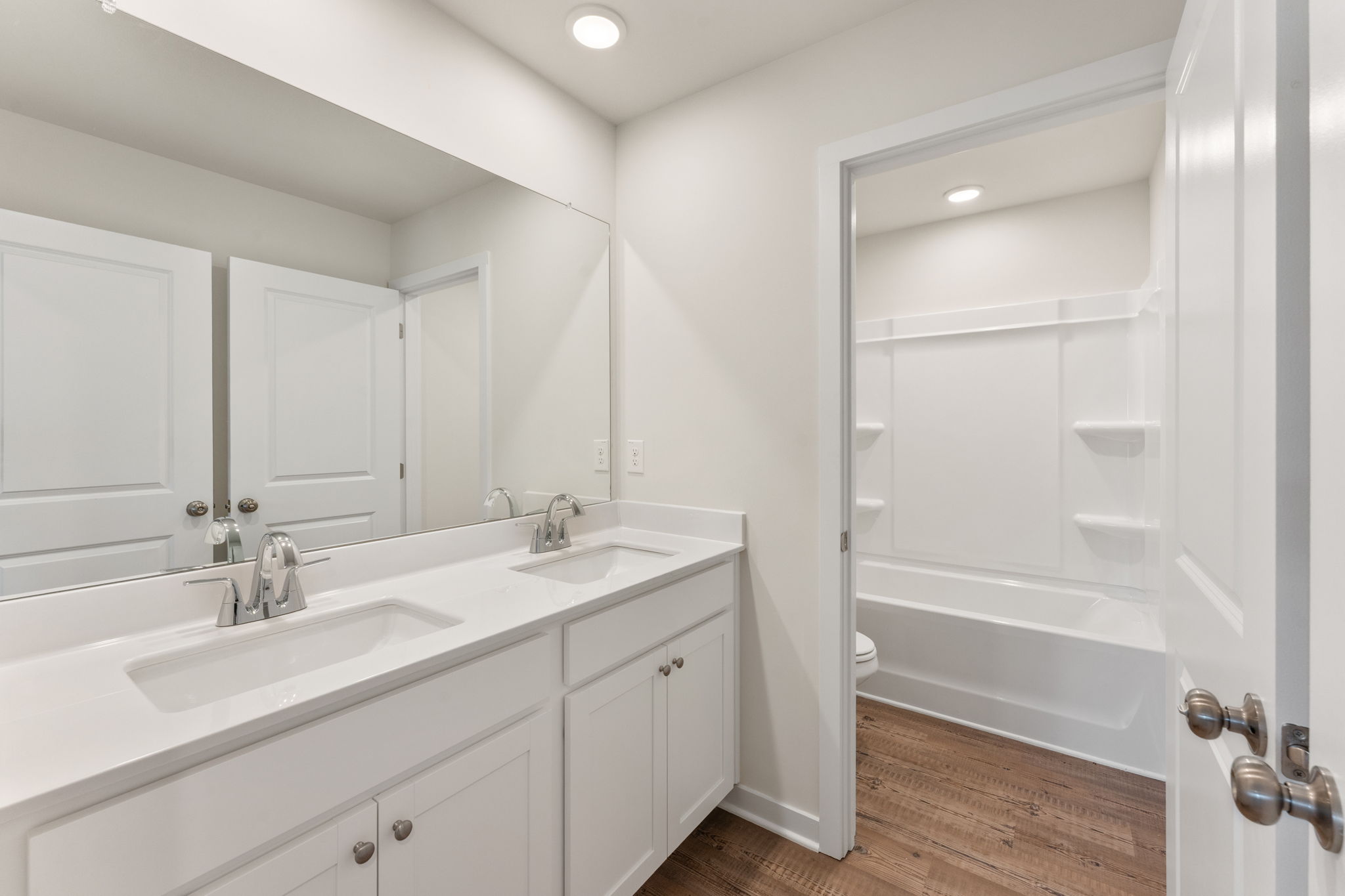 A bathroom with a tub sink and a shower.