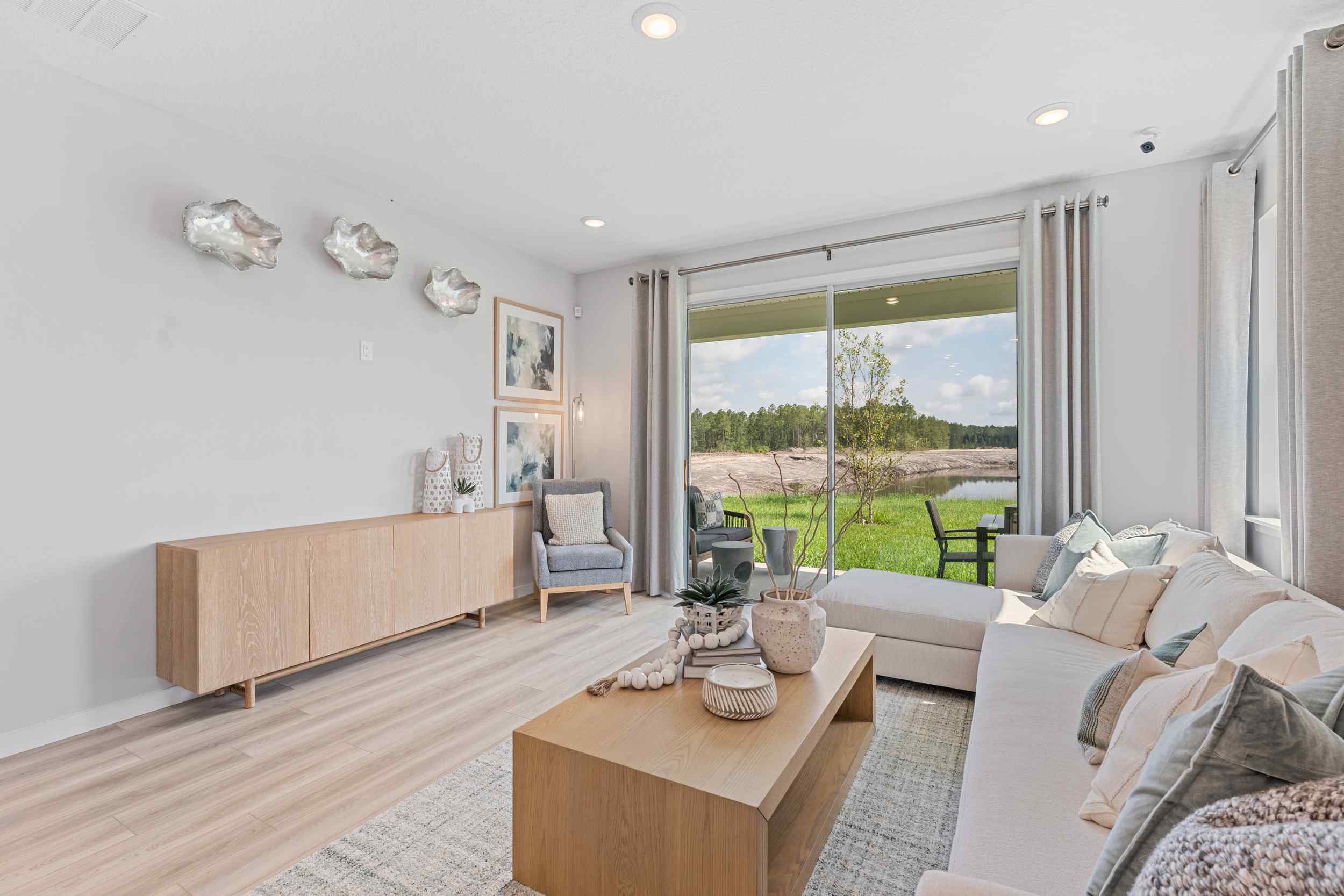 Laurel II Model Home Living Room with Sectional Couch and Sliding Patio Doors at Camden Woods in Kingsland, GA