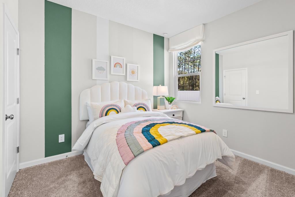 A bedroom with a bed and a window.