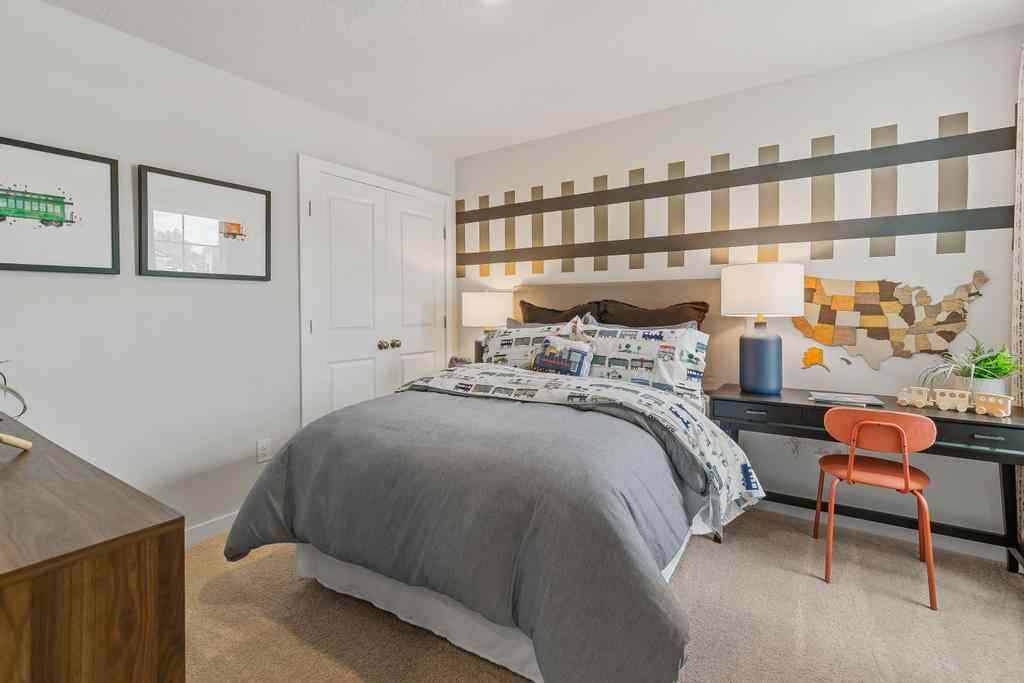 A bedroom with a bed and desk.